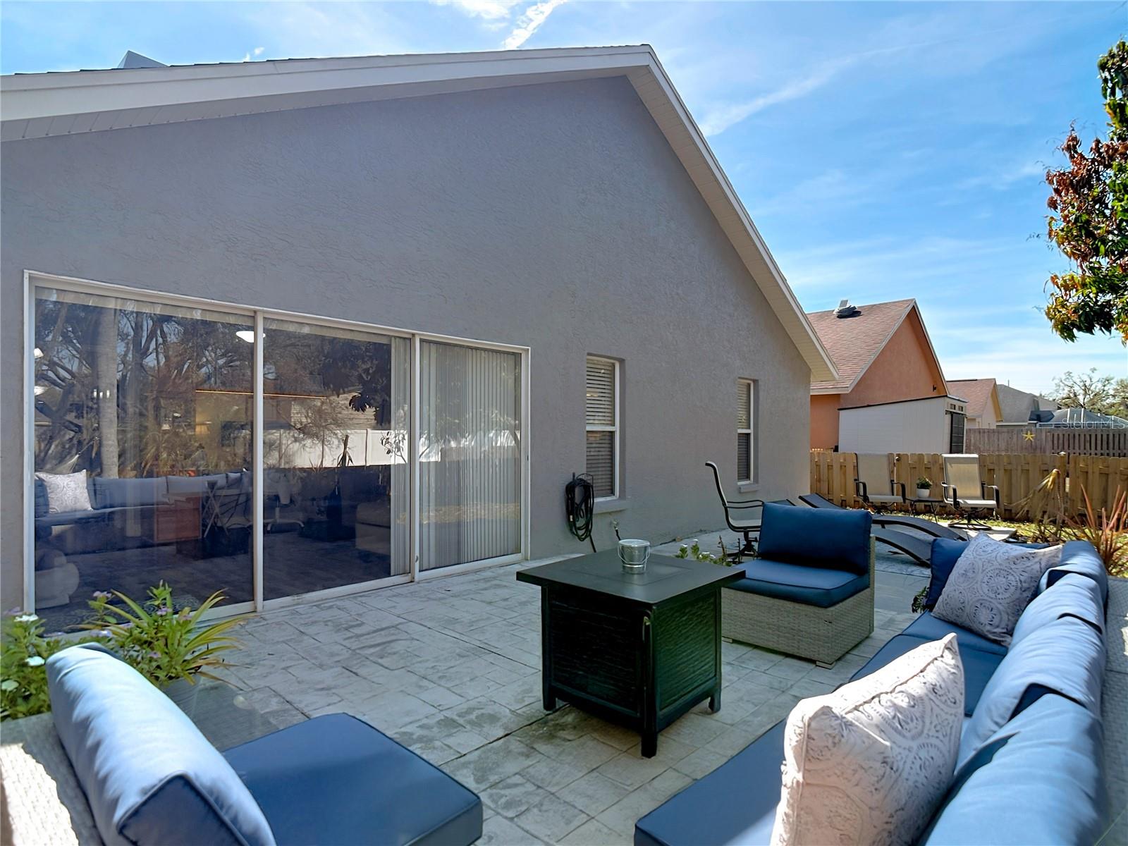 Enjoy the back & side patio for your morning coffee and the newly poured back patio (2024), perfect for gatherings and outdoor entertaining.