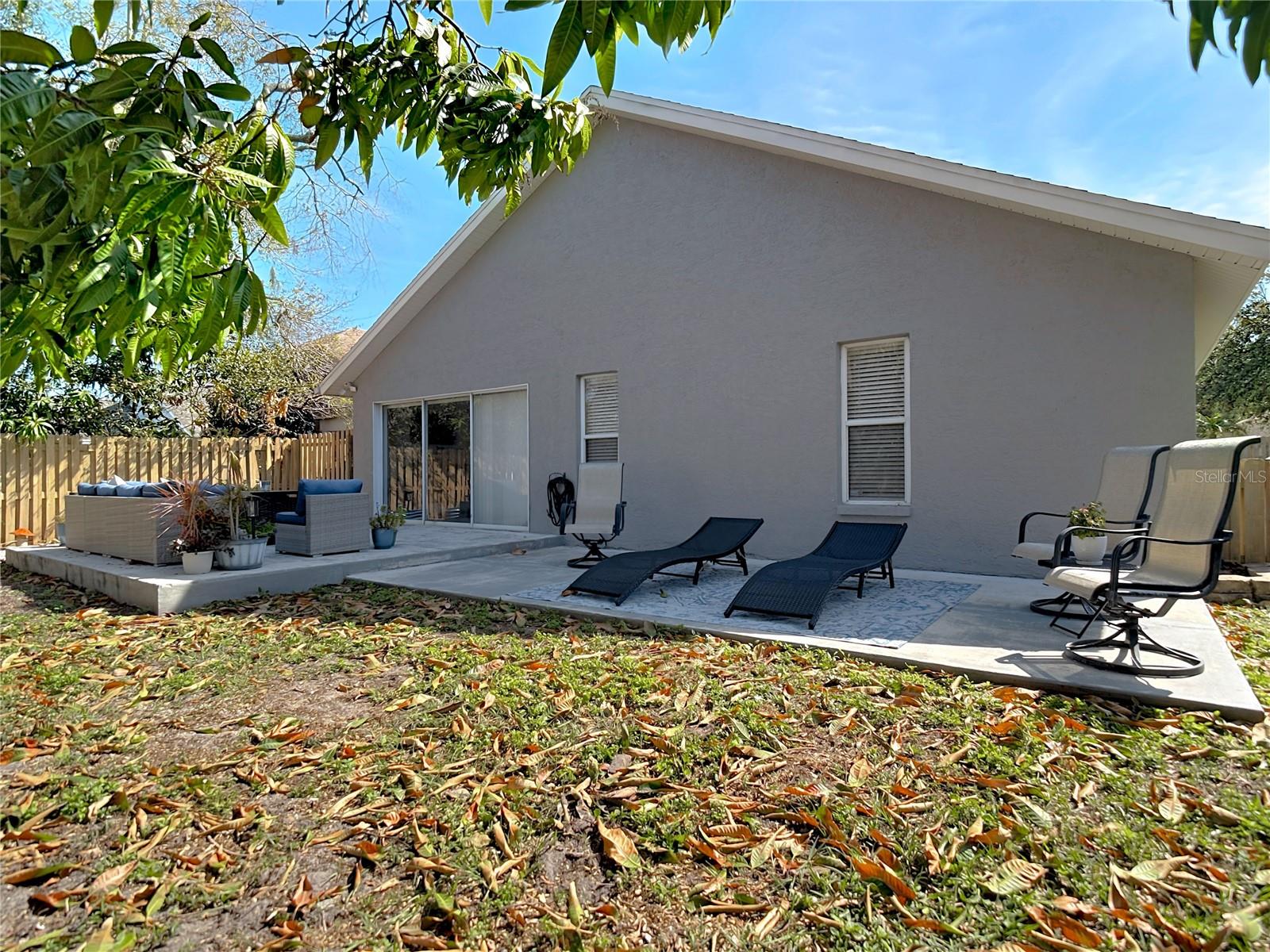Enjoy the back & side patio for your morning coffee and the newly poured back patio (2024), perfect for gatherings and outdoor entertaining.