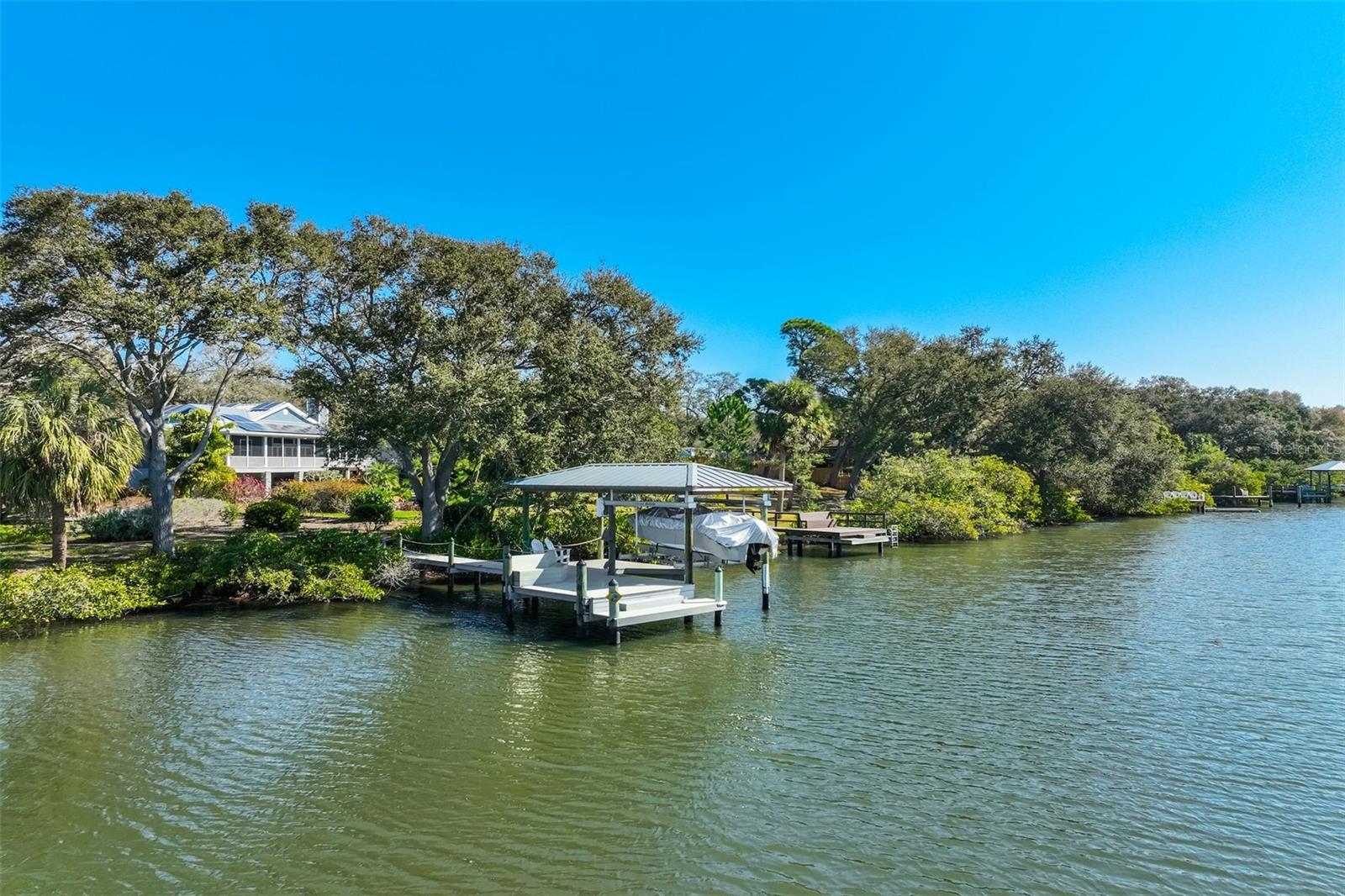 Covered boat slip with 7000 lb lift, boat included with sale