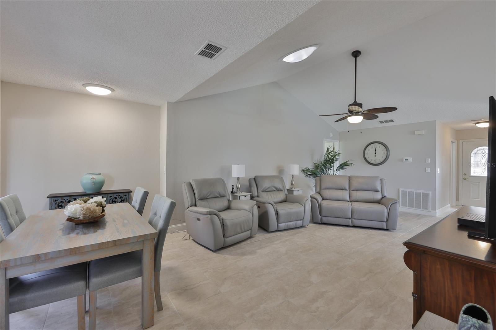 Solar tubes in both the extended space and living room bring in natural Florida sunshine into the space and the high ceilings make the rooms feel large and open.