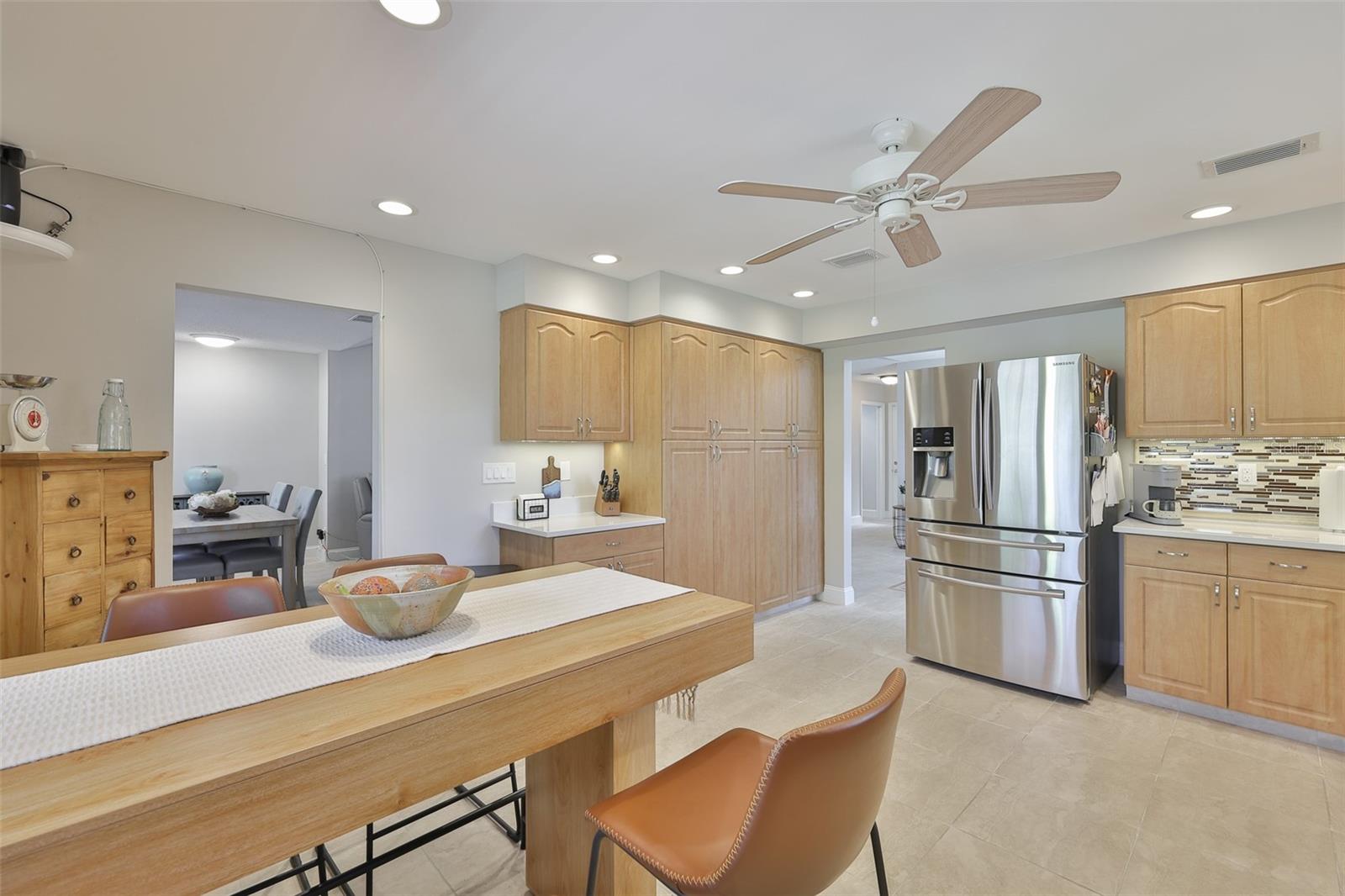 Lots of counters, cabinets and room for a full eat in space compliment this stunning kitchen.