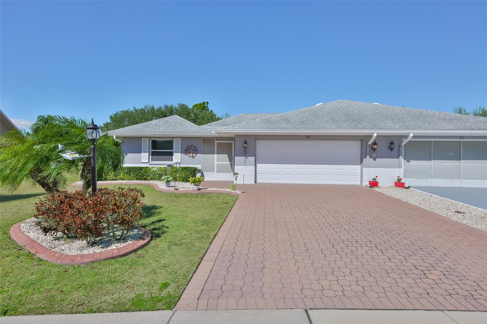Custom Pavered drive and walkway with curbing for all of the landscaping.