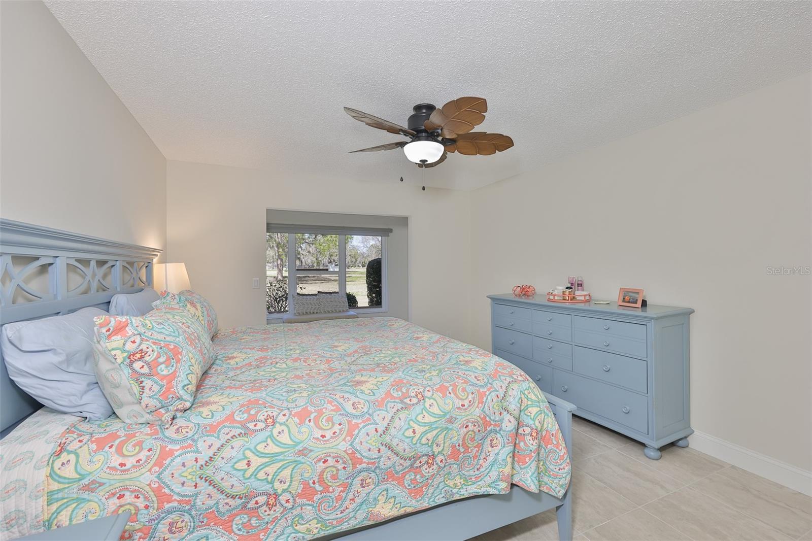 Primary bedroom is huge with a separate sitting area and large window with a view of the greenspace surrounding the home.