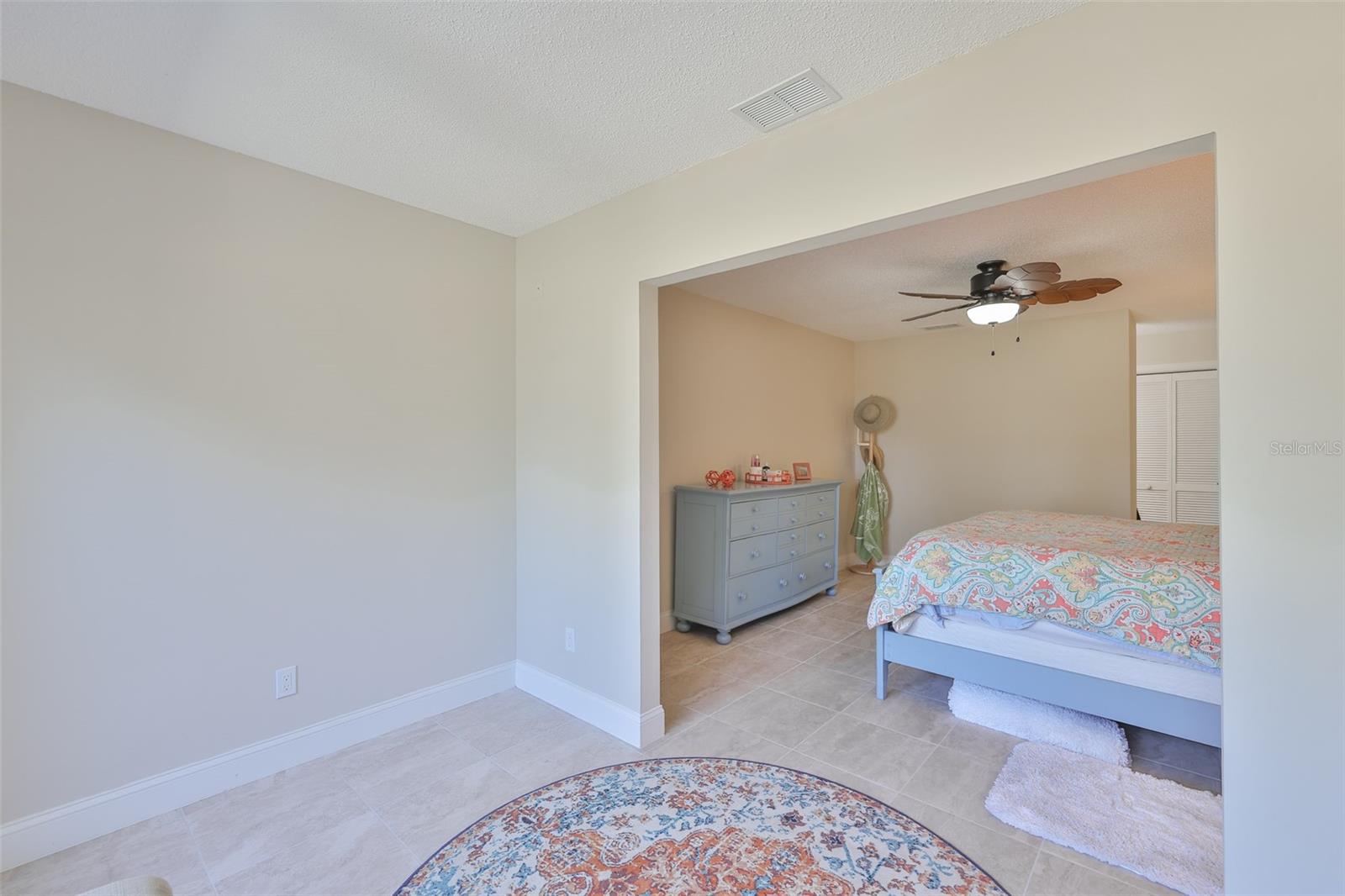 View from the sitting area into the primary bedroom.