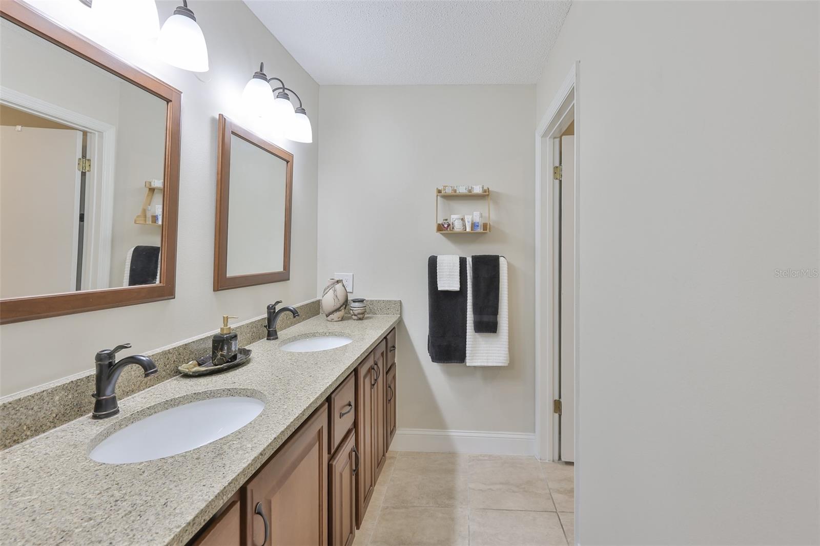 Primary bathroom is beautifully updated, boasts dual sinks and contemporary fixtures.  Water closet and shower are in a private area of their own.