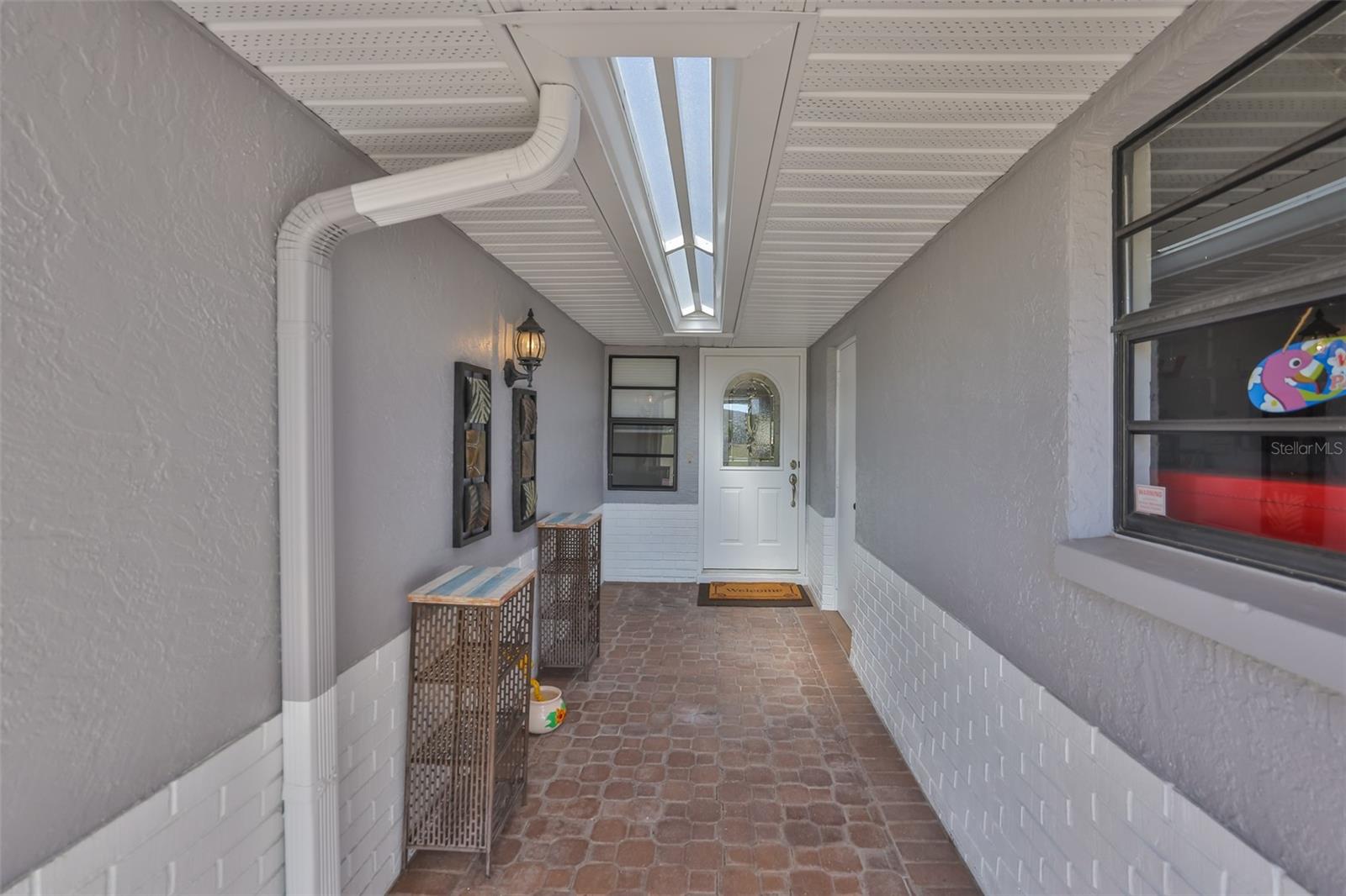 The screened front porch, walk way area is covered to help protect you and your guests from the elements and give some security for packages.