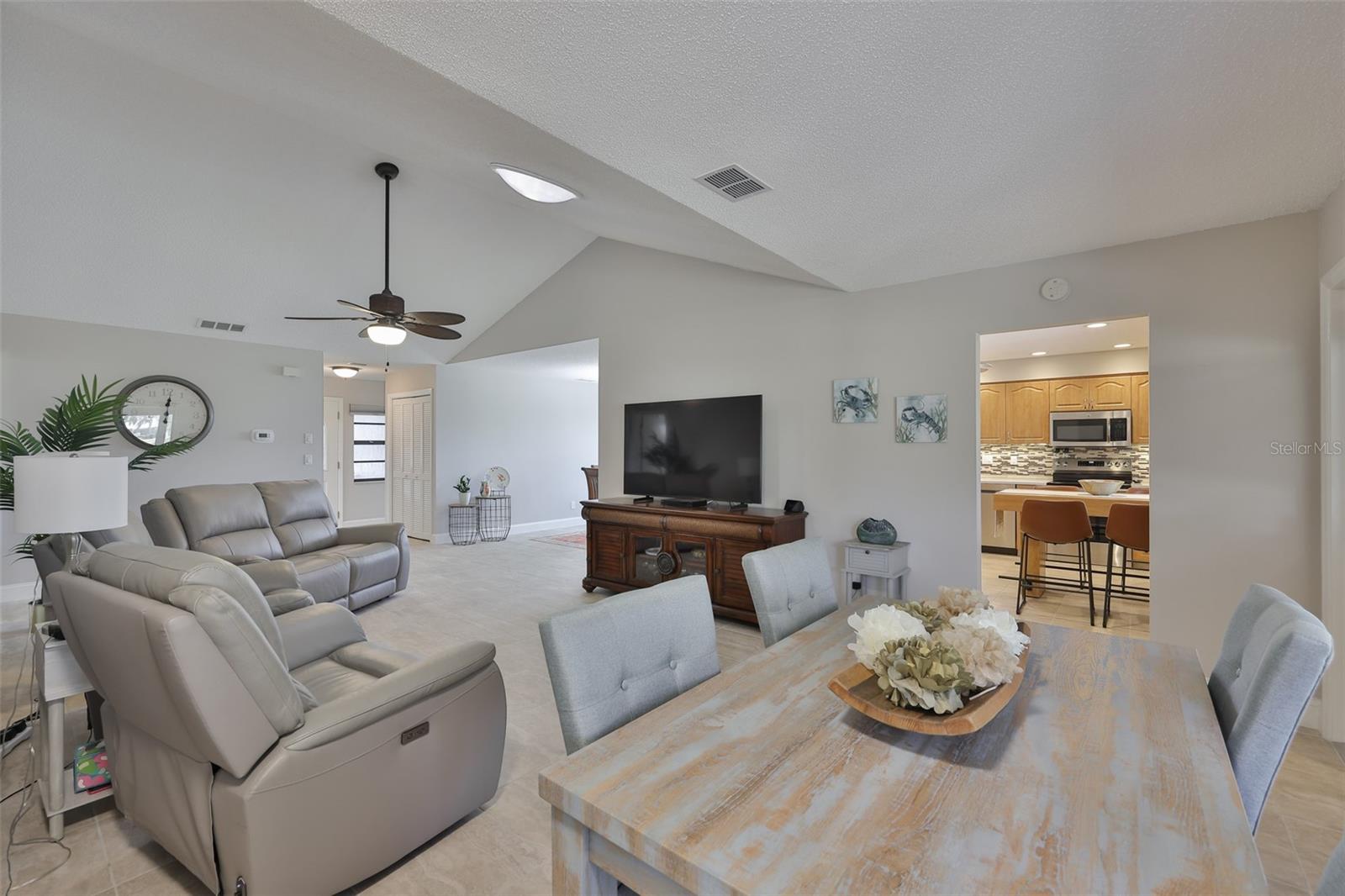 Clean, spacious and bright is exemplified in this home.  Notice the high ceilings and solar tubs in the living room providing natural light into the space.