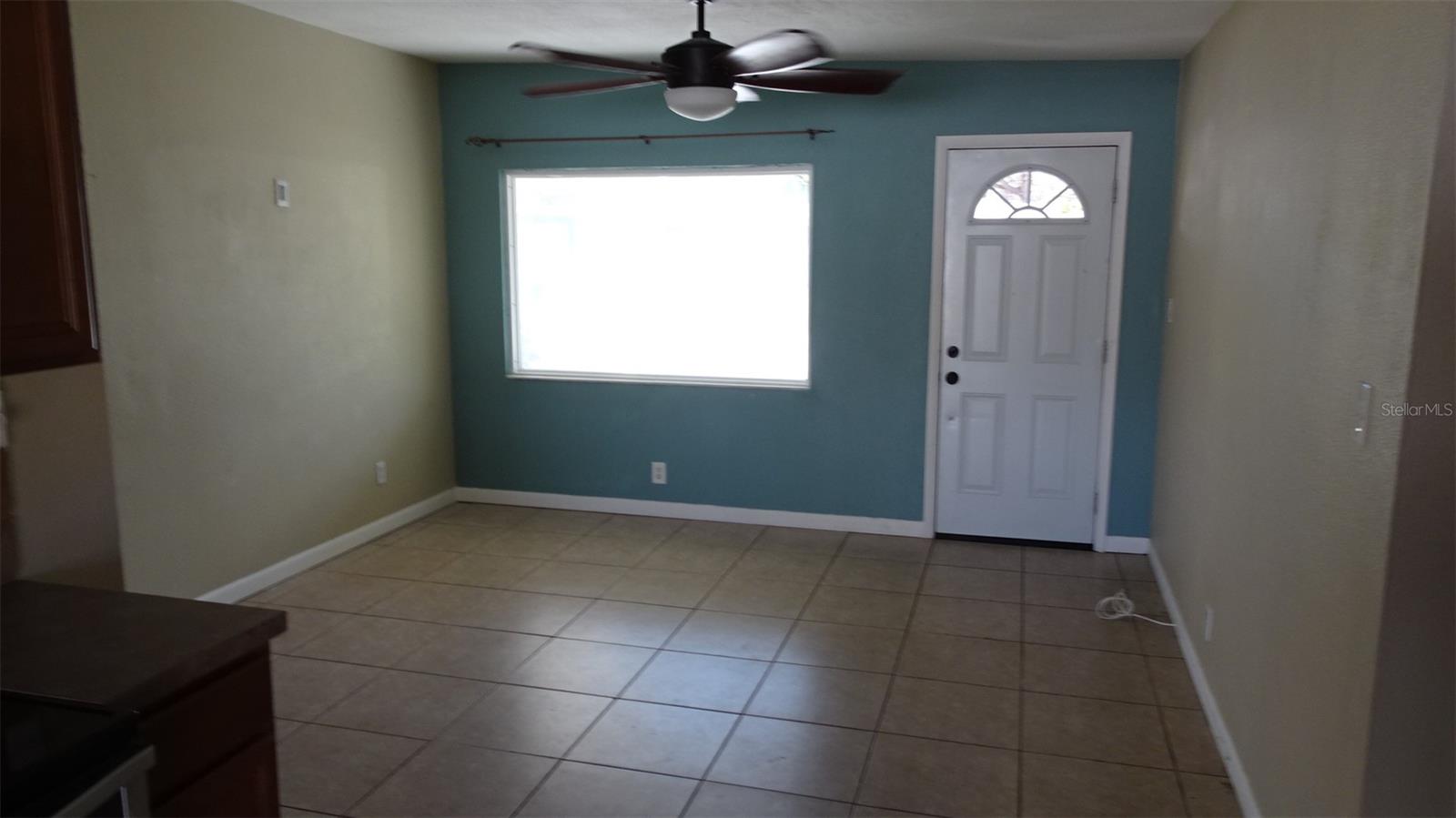 Standing in kitchen looking towards front door and living room.