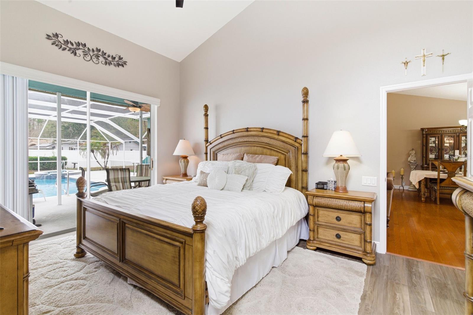 Primary Bedroom - peaceful, light-filled suite with poolside views