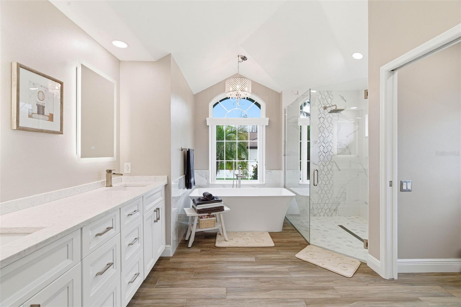 Ensuite Bathroom - features a finished walk-in shower with stunning reflective tile accents.