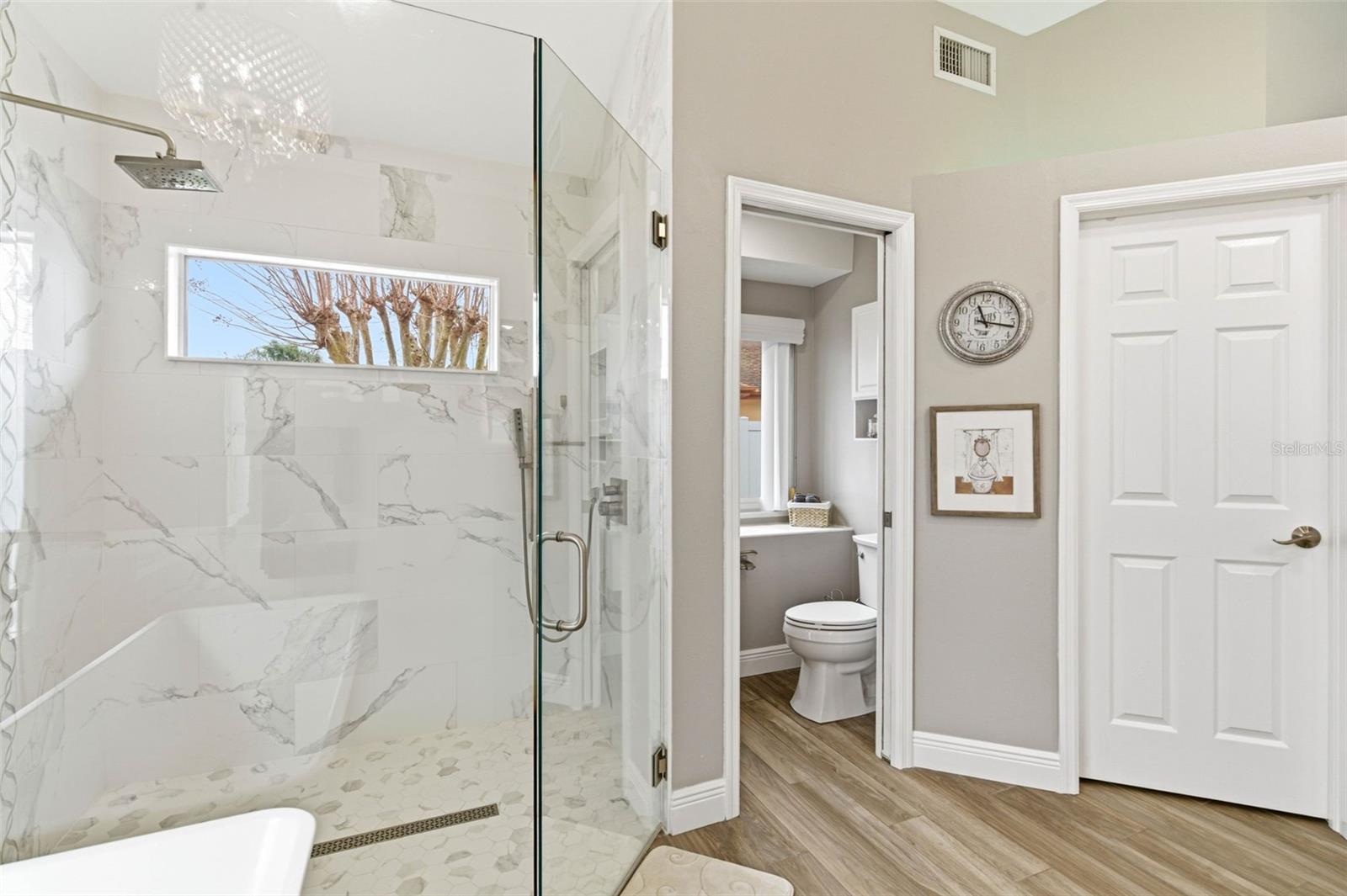 Frameless glass shower; private water closet with charming dutch doors for functional privacy
