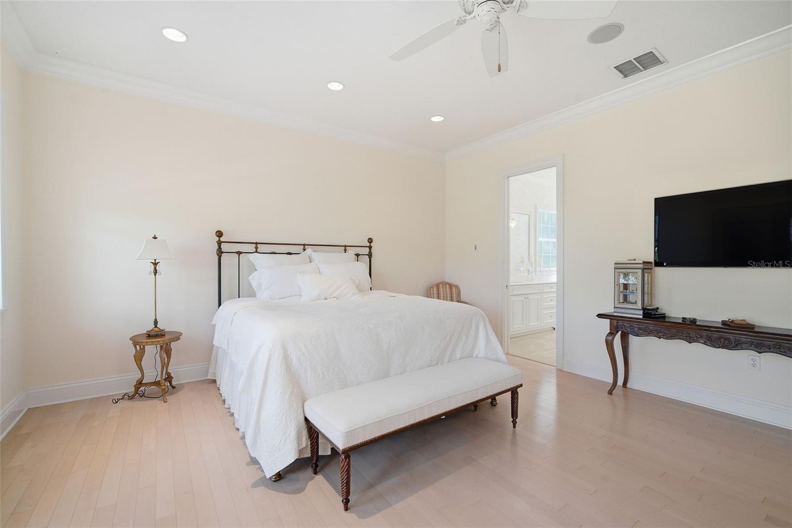 Primary Bedroom with wood floors and walk-in closet.