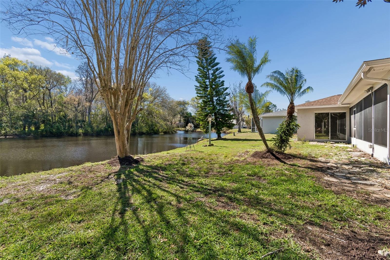 Backyard w/Mature Trees & View of Pond