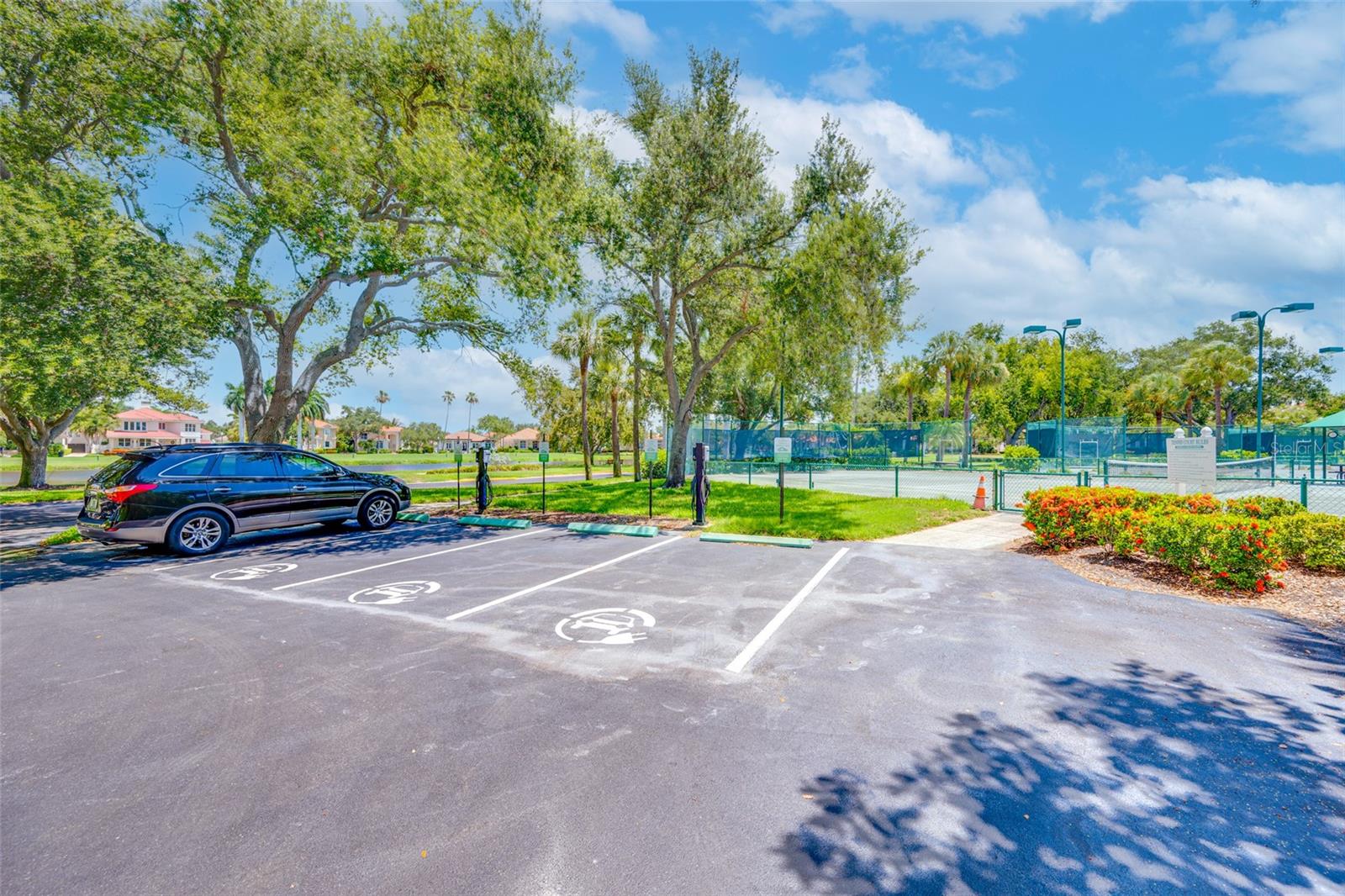 Electric vehicle charging stations by Tennis courts