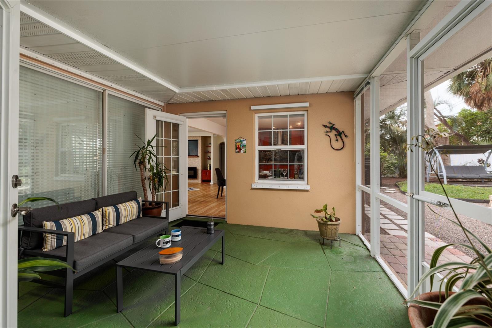 Screened porch offers outdoor living space with views of your outdoor oasis under a roof!