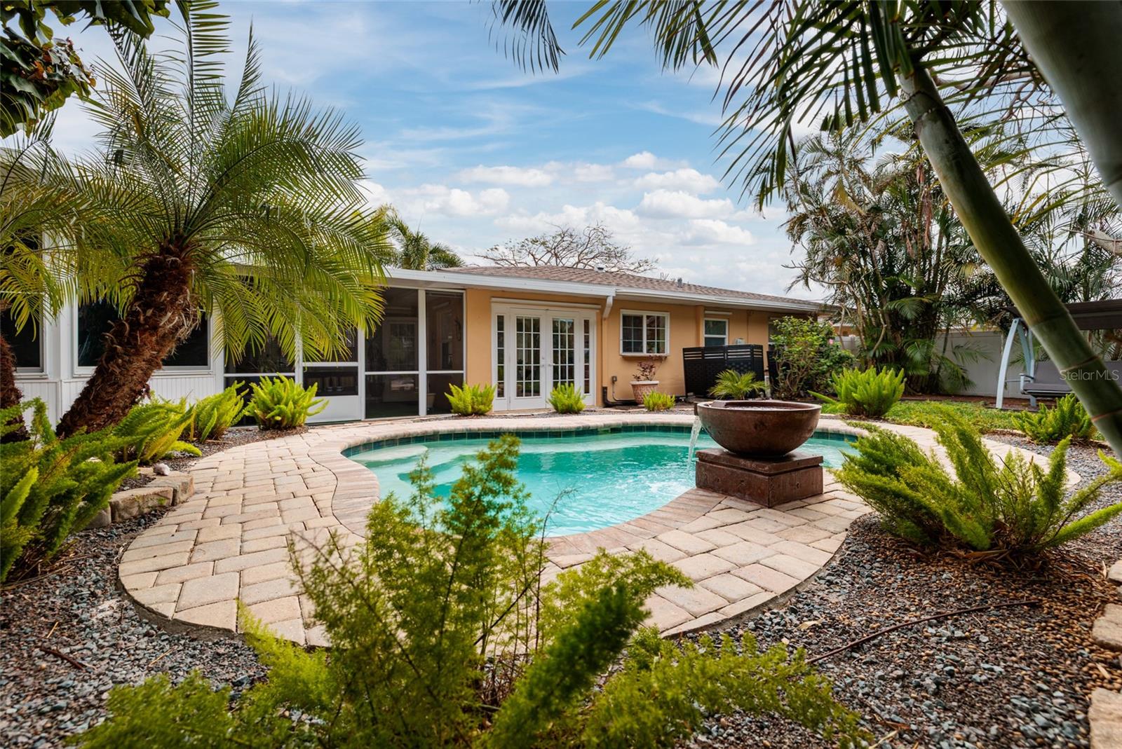 Pavered pool area that follows the shape of the pool!