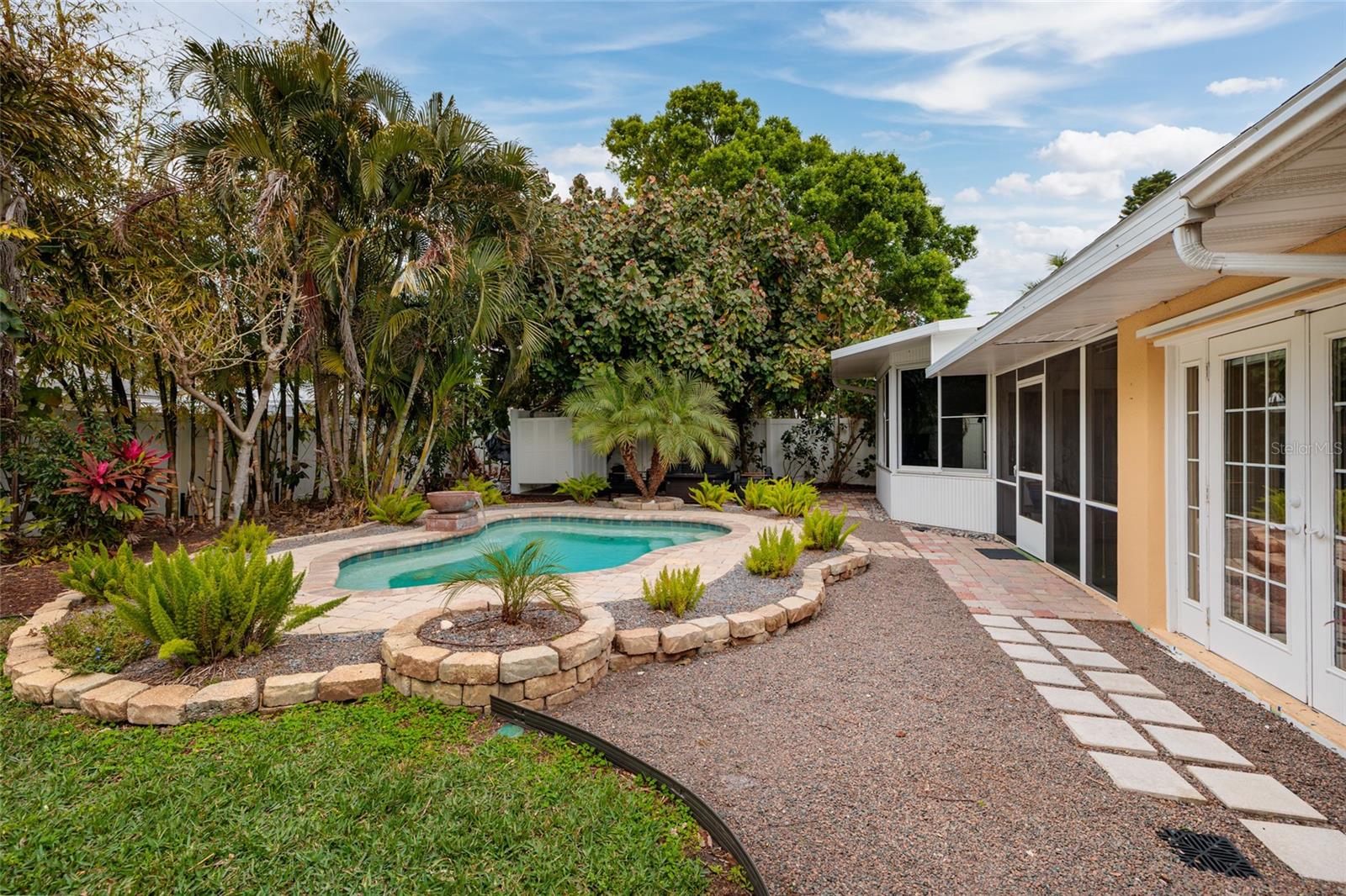 Pool with firepit and shower beyond. French drains also a great feature.