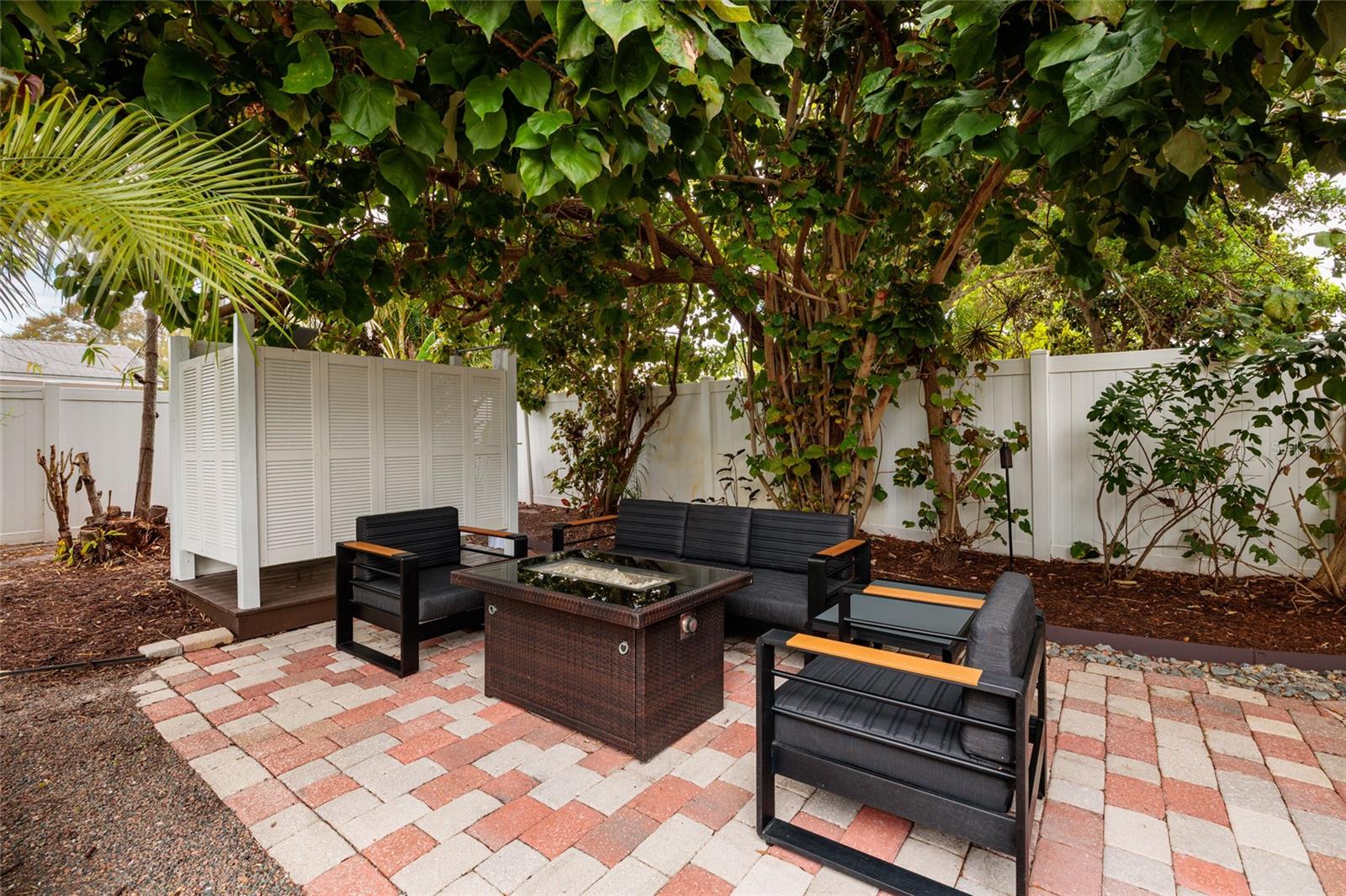 Pavered firepit patio for more outdoor living options. The outdoor shower is right behind the patio!