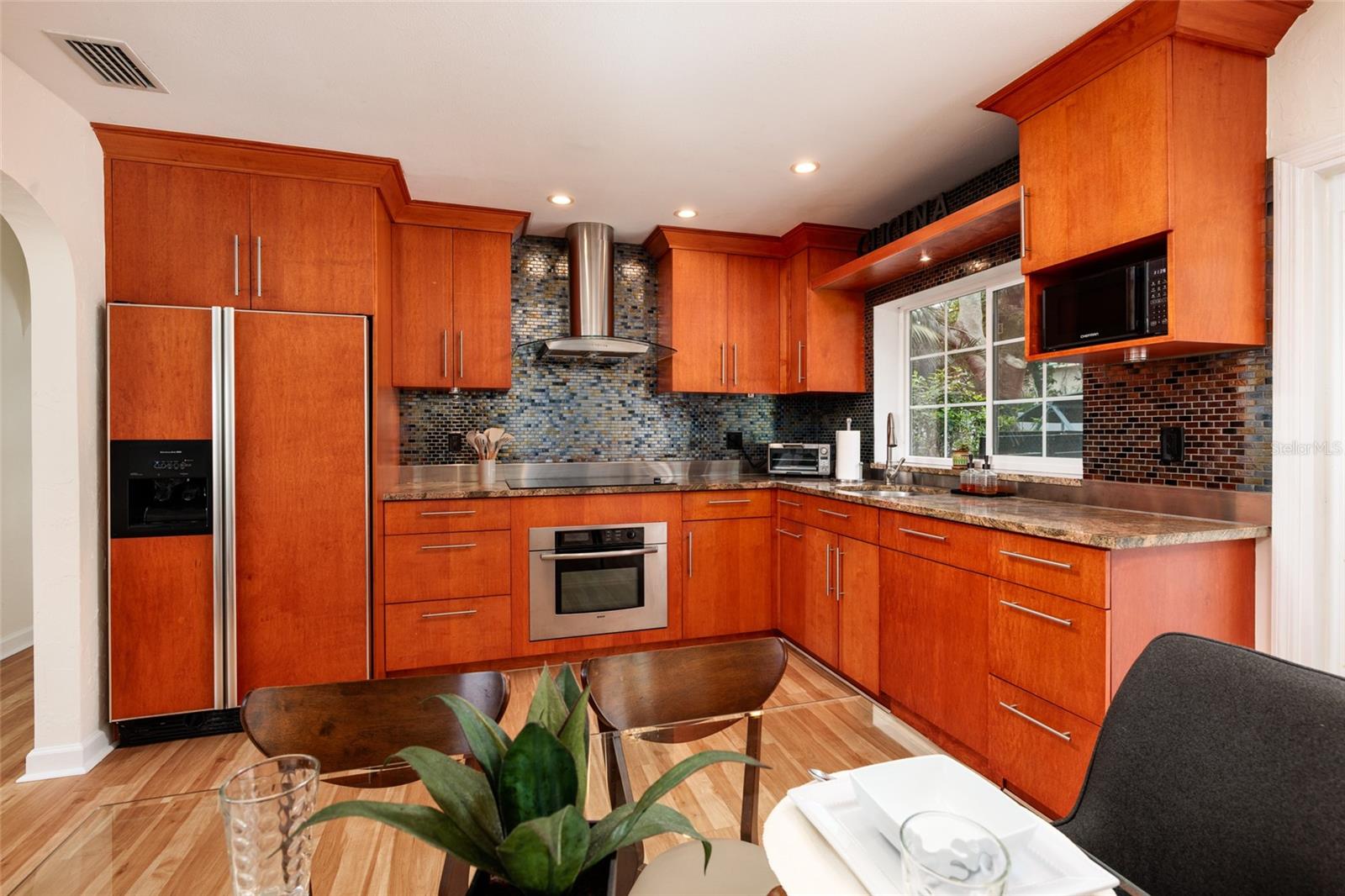 Stainless Bosch appliances, designer range hood, built in microwave cabinet and under counter lighting.