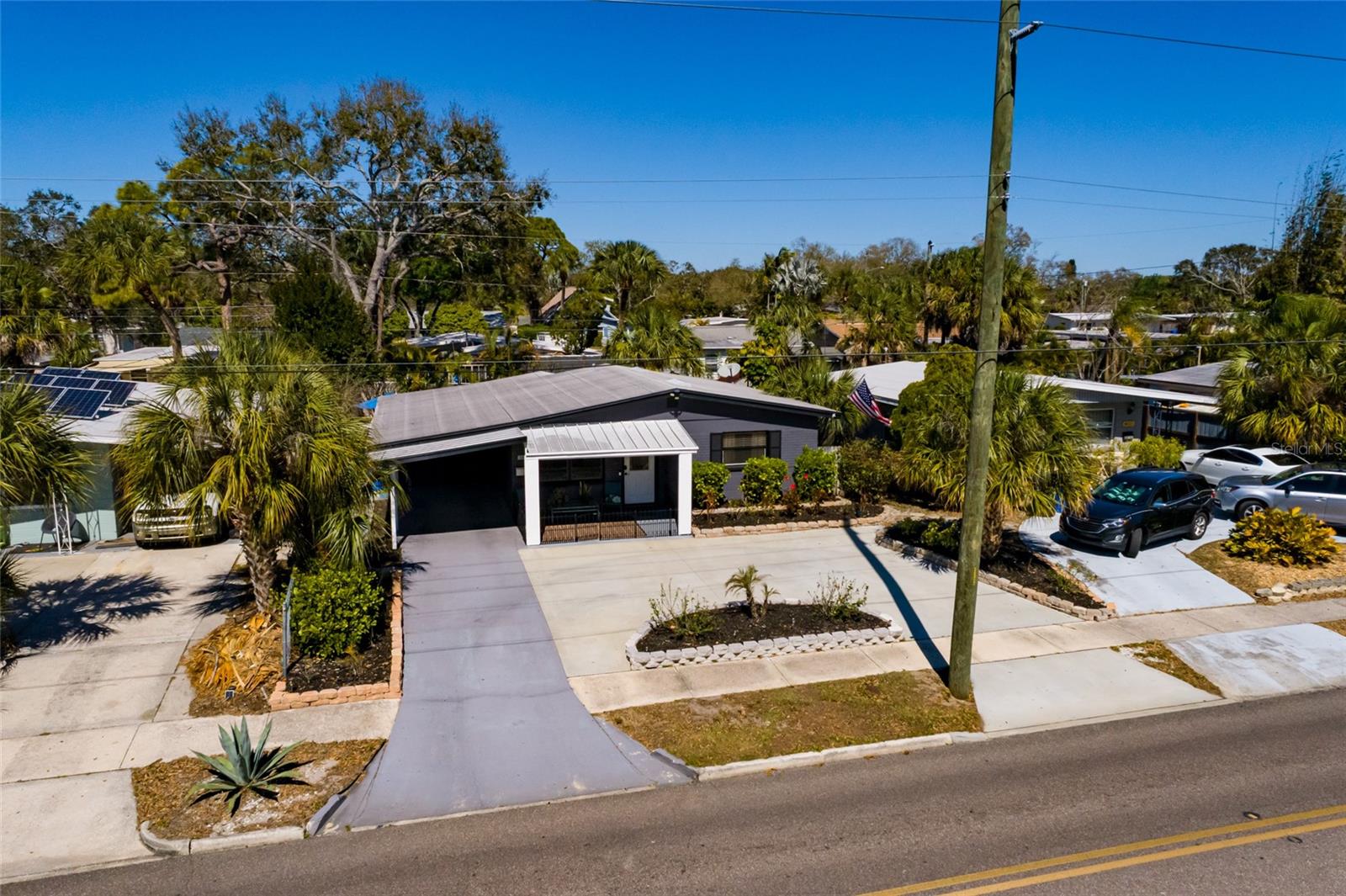 Large front porch. Plenty of parking with circular driveway & carport.