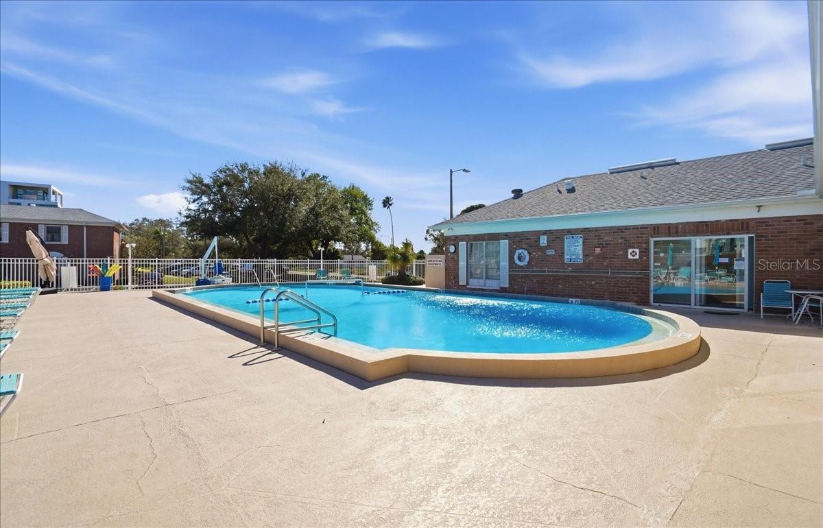 Large heated swimming pool aside Clubhouse with saunas, meeting room, kitchen, and library.