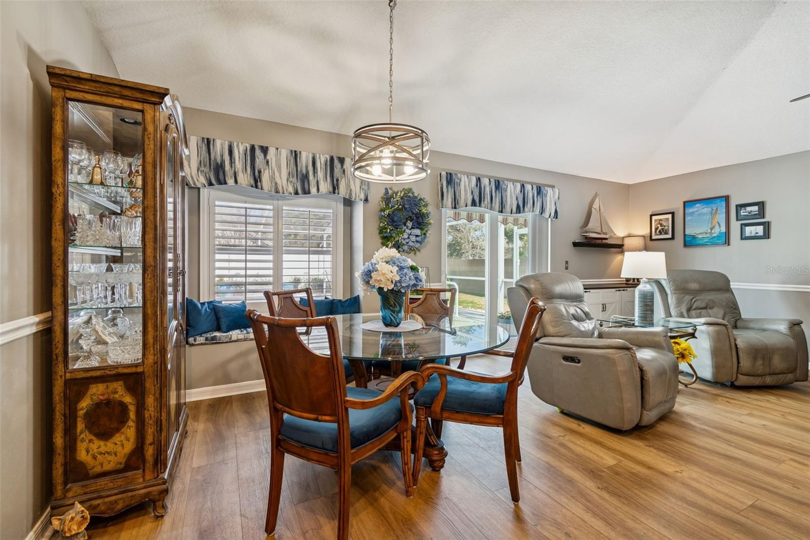 The beautiful bay window with custom Plantation shutters offers the natural light and wonderful views of your outdoor entertaining space.