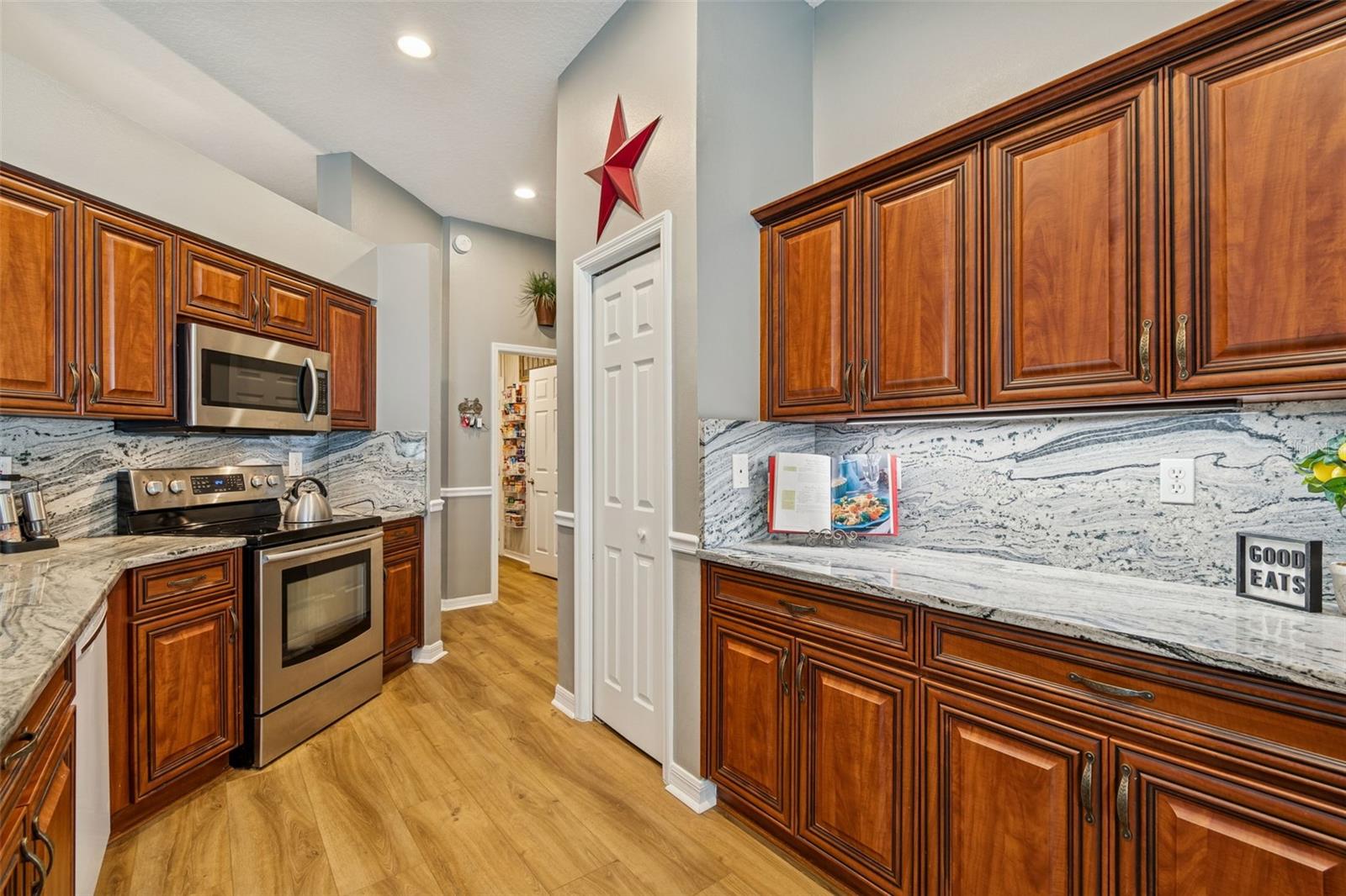 Notice the under cabinet lighting and seamless granite backsplash/counter combo offering plenty of space for meal prep.