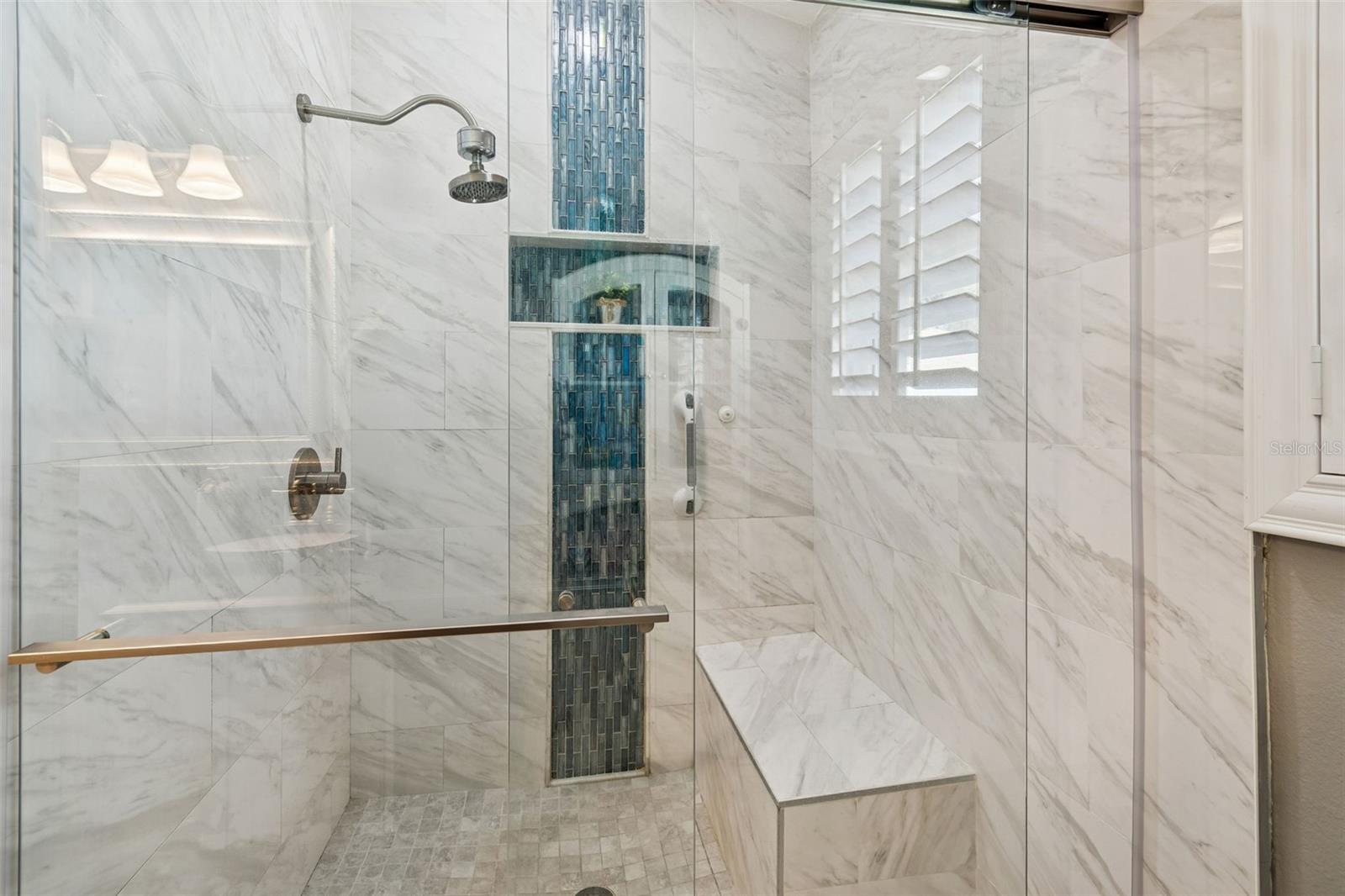 Owner's bathroom has been recently updated with a custom frameless glass shower and seamless tile.