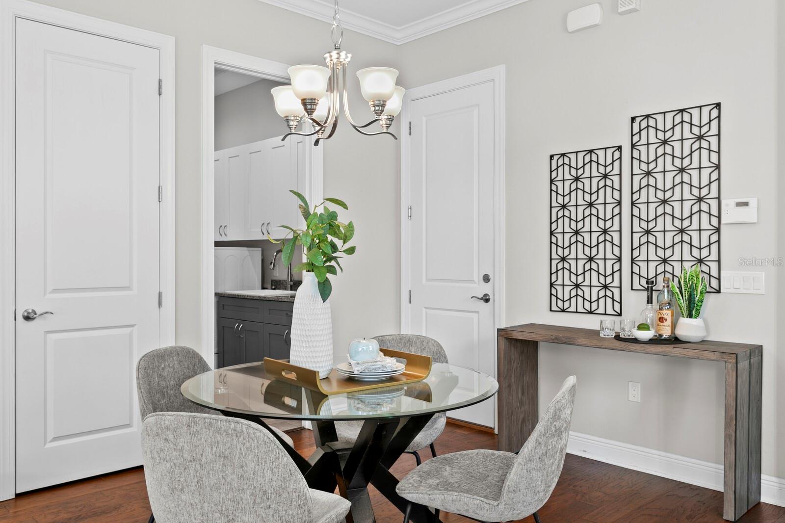 This view shows the dining table, garage door, laundry and the powder room.