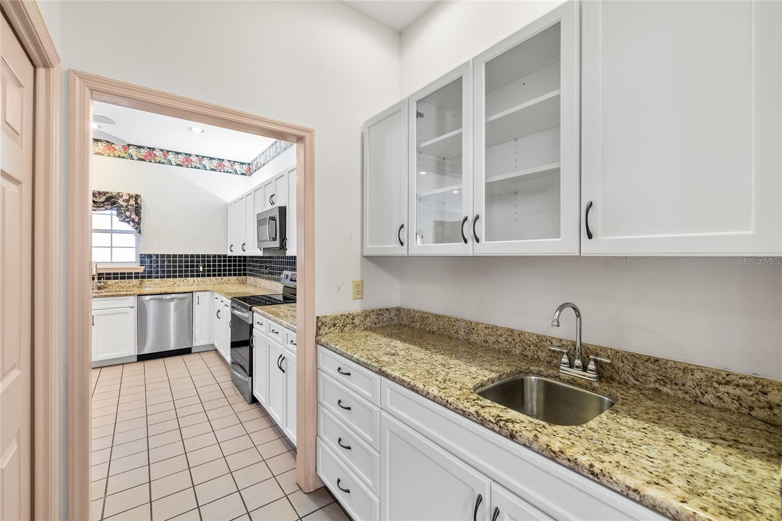 Wet bar area is between the kitchen and the formal dining room. More cabinet spaces too!