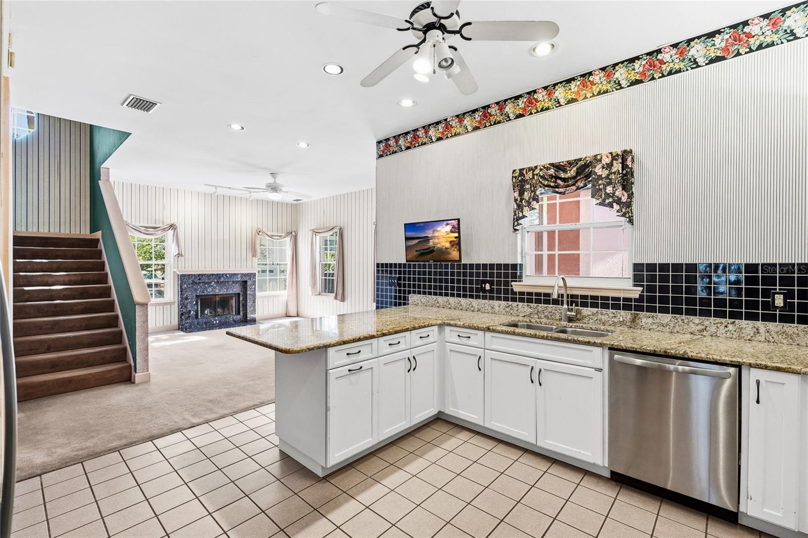 Spacious kitchen opens up to the family room with cozy fireplace