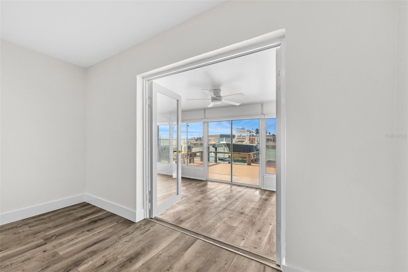 french doors off primary bedroom to sunroom