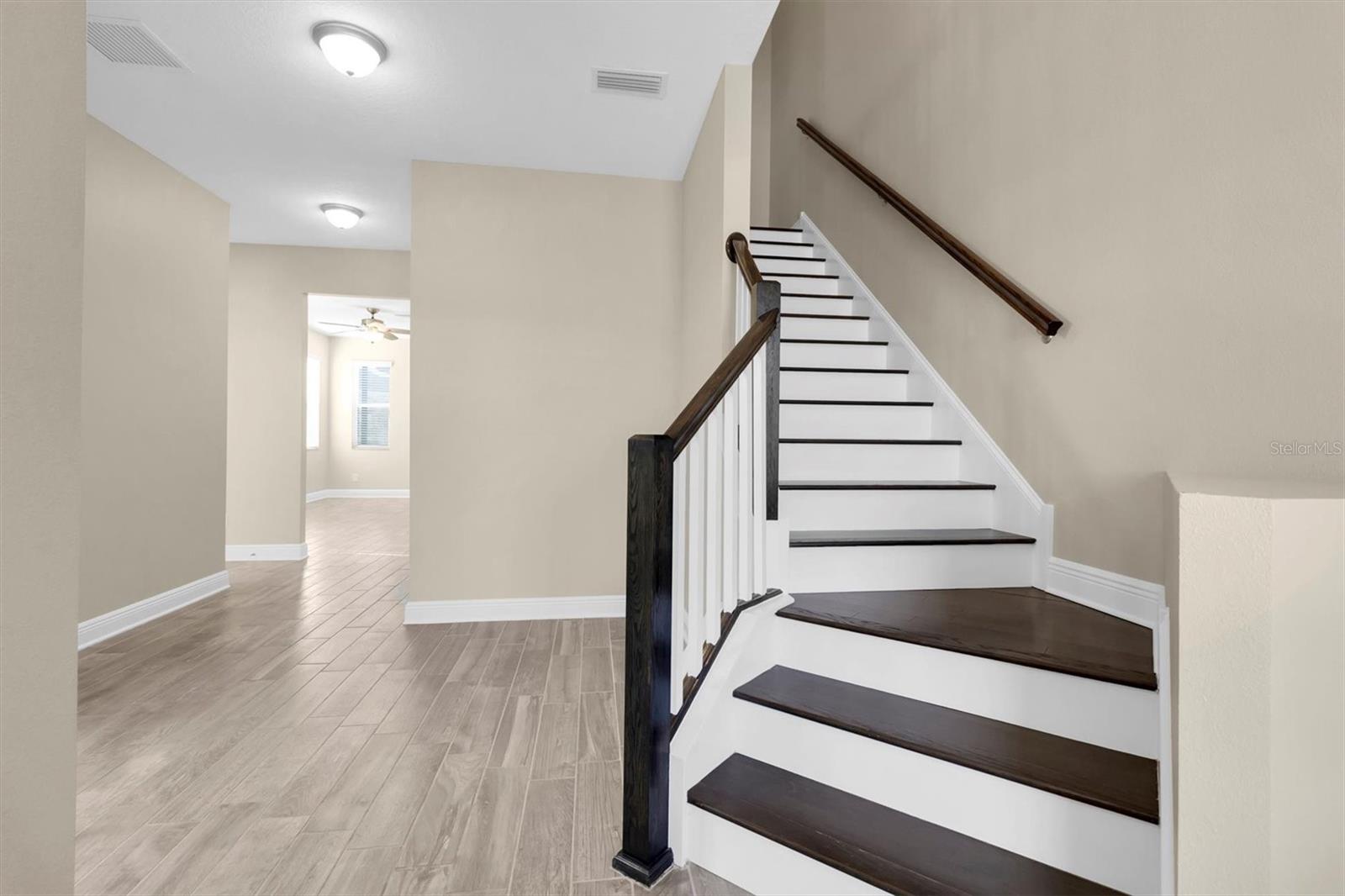 IMPRESSIVE ENTRY WITH WOOD STAIRS