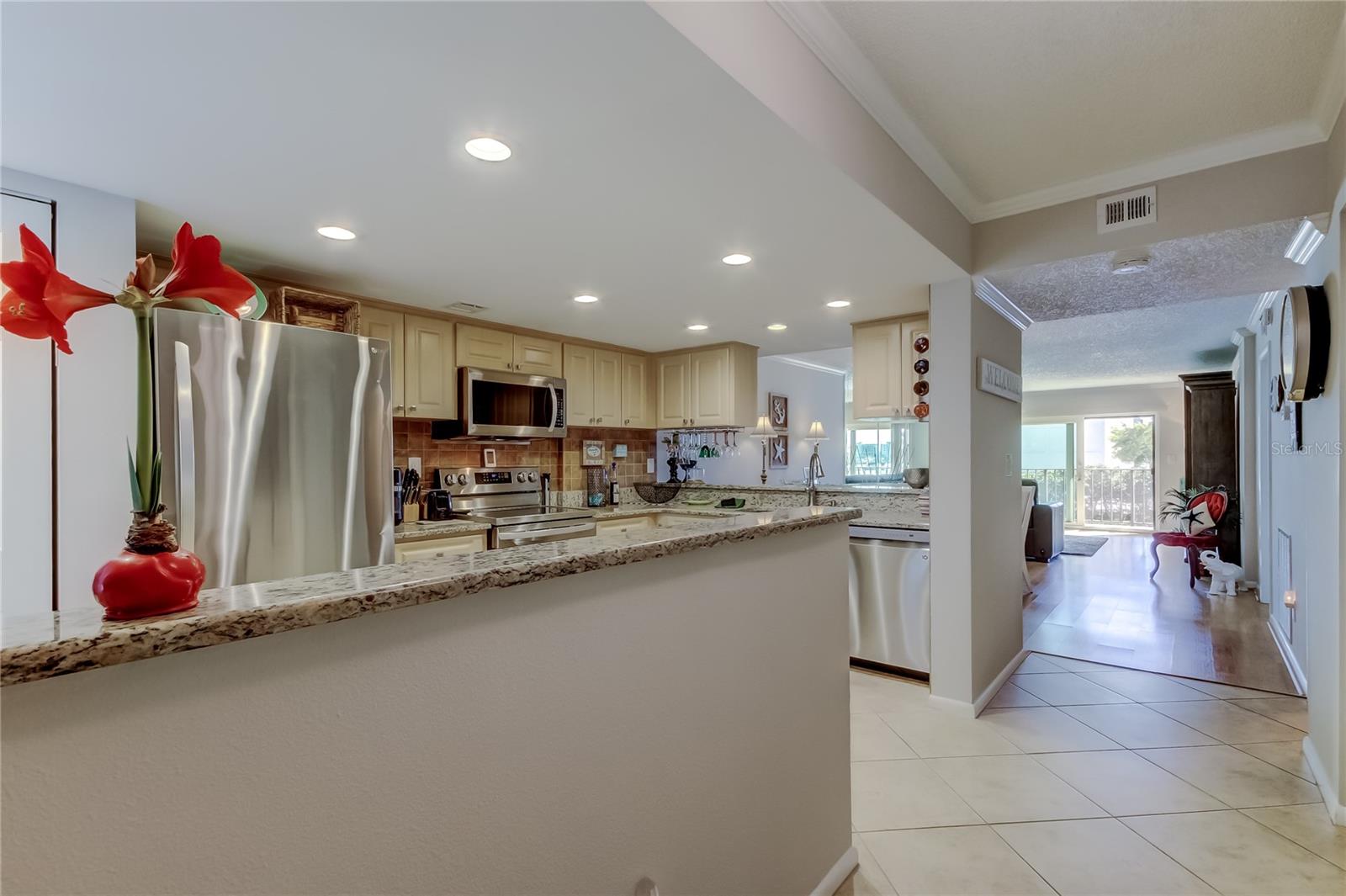 Spacious kitchen with granite countertops, pass-through, recessed lighting, and so much more.