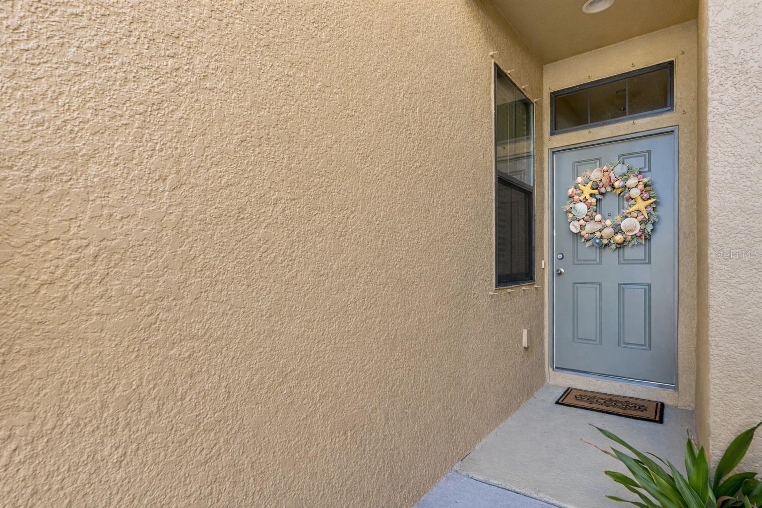 Gated Bay Isle Landings townhome with fresh exterior updates and welcoming coastal curb appeal.