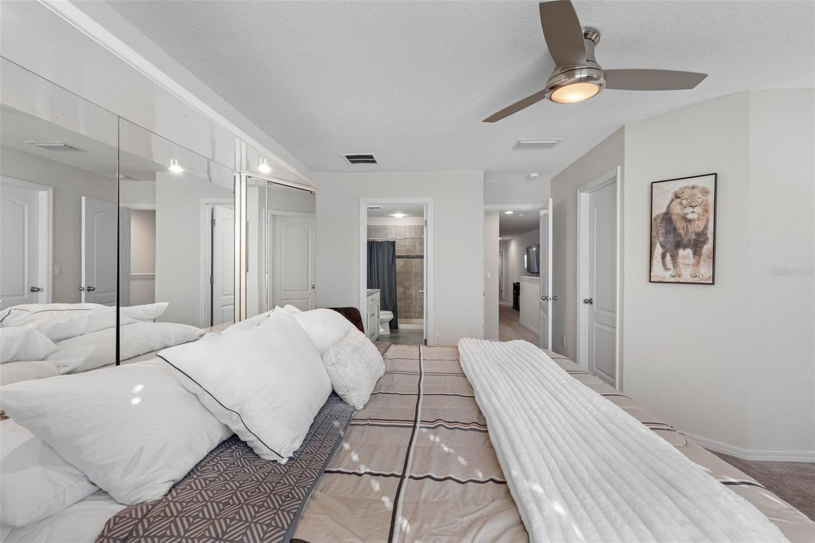 Spacious primary suite offering comfort, privacy, and room for a king-size bed.