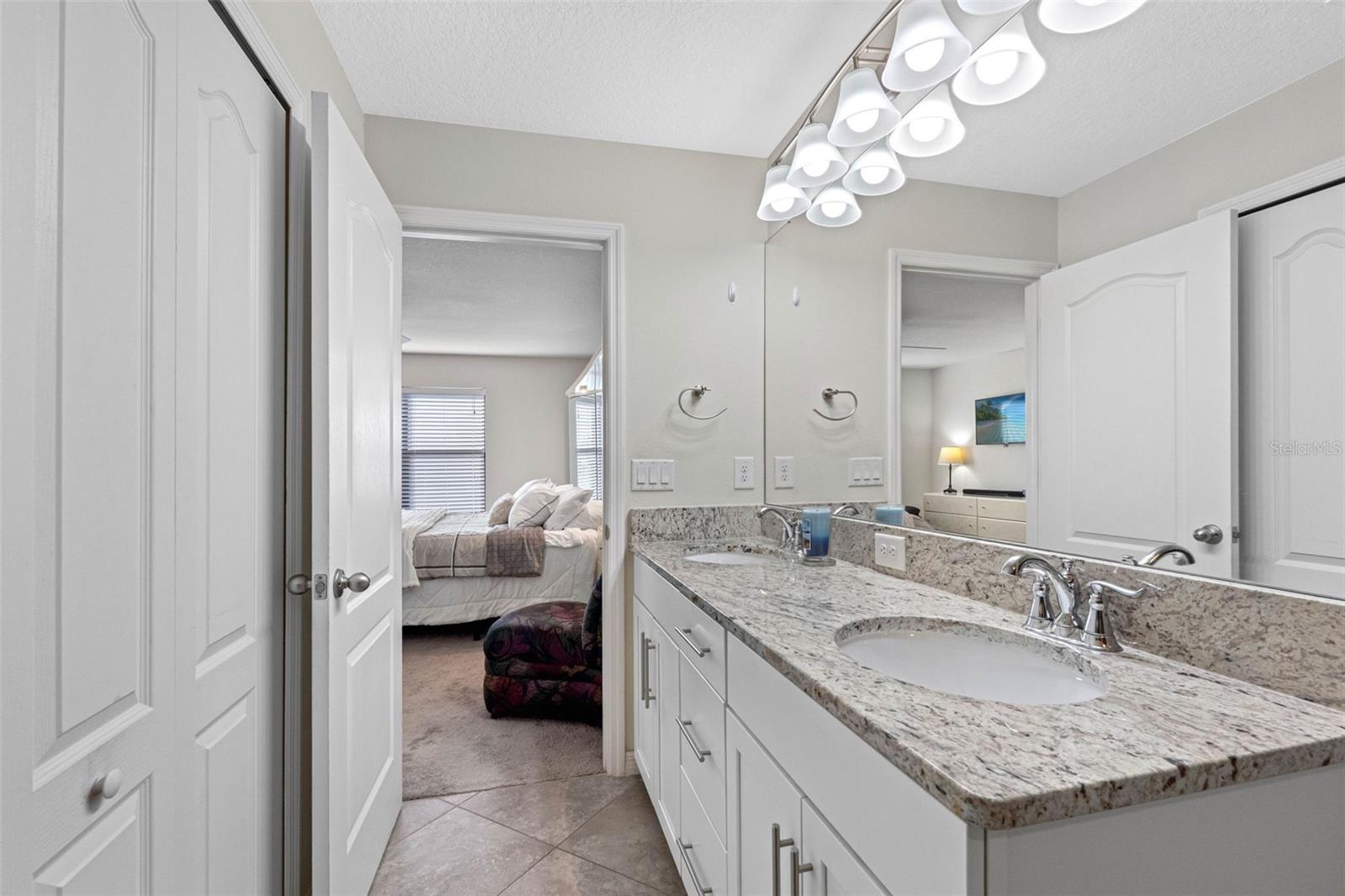 Primary en-suite bath with walk-in shower and clean, modern finishes.