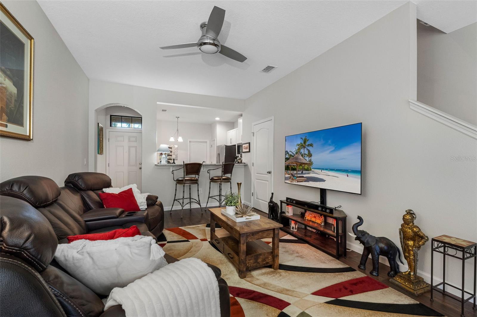 Spacious living room with high ceilings and abundant natural light, creating an airy, comfortable atmosphere.