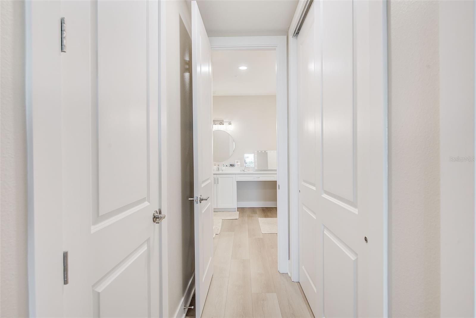 Closets between primary bedroom and primary bath.