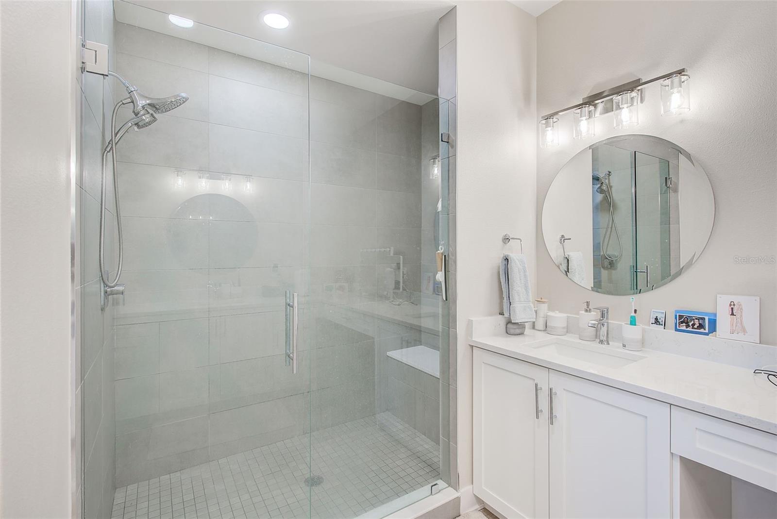 Huge walk in shower with seat.