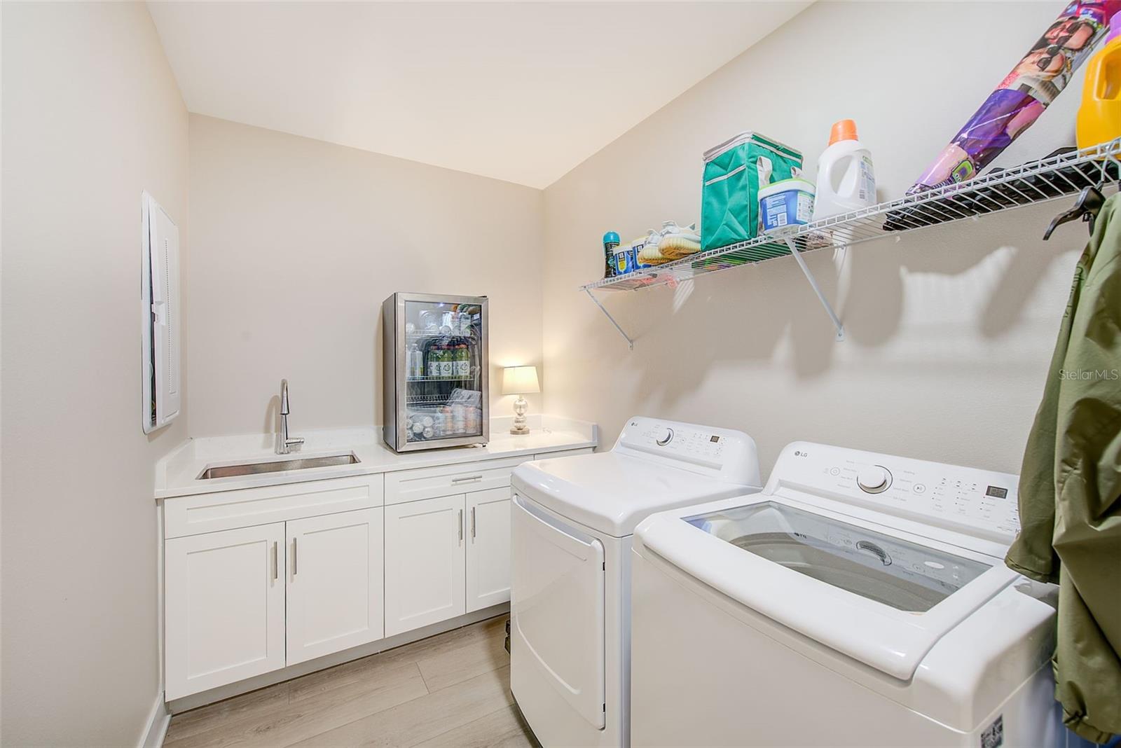 Spacious laundry room with plenty of storage.