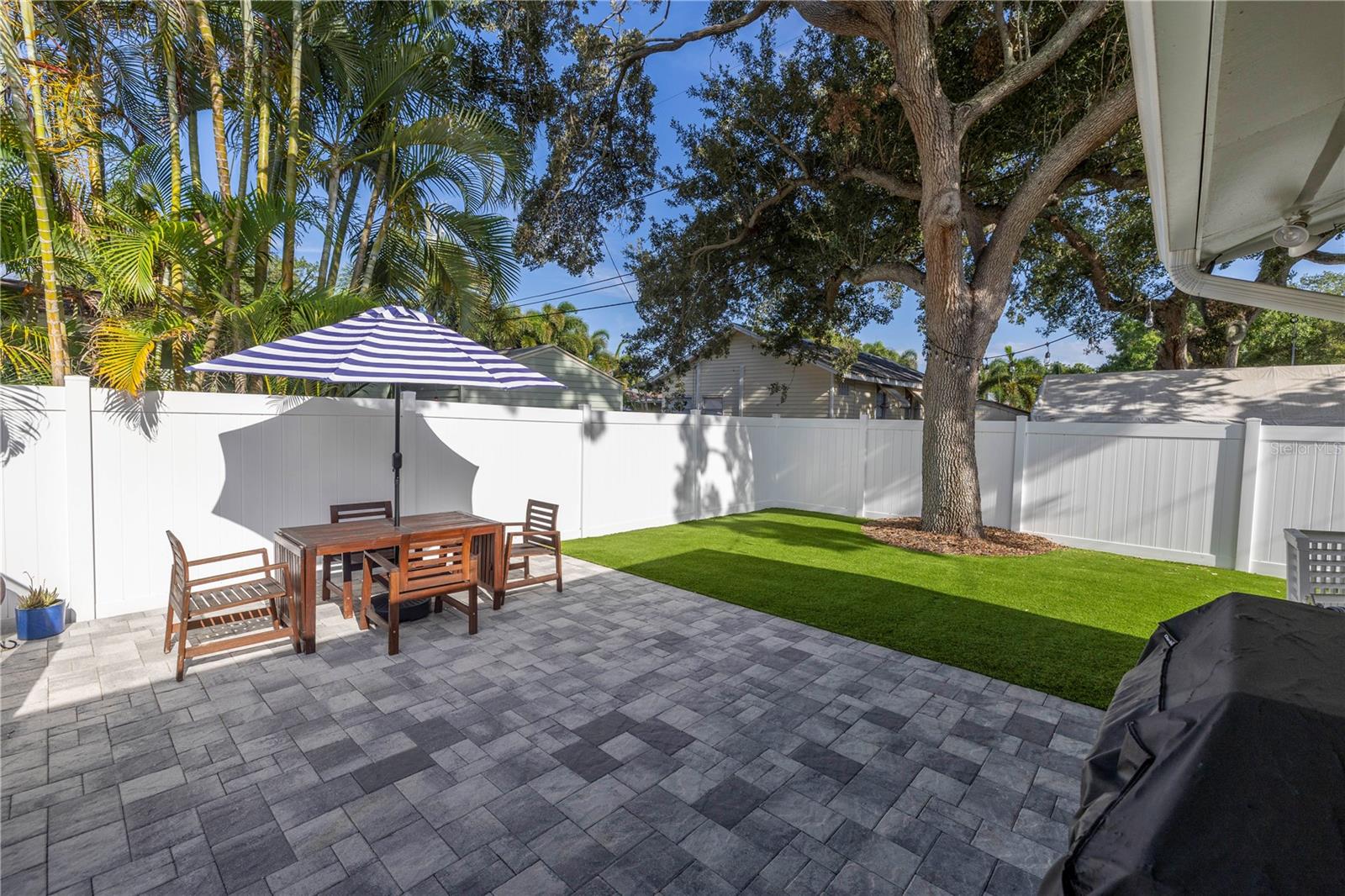 Paver patio w/ artificial grass yard