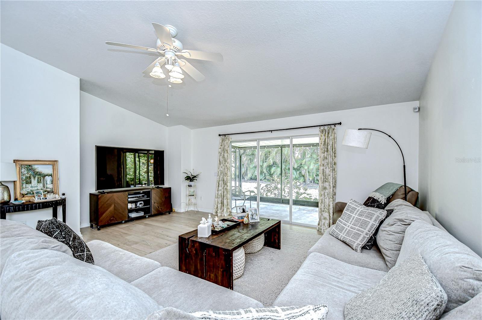 Large family space with direct access to the screened patio through sliding glass doors.