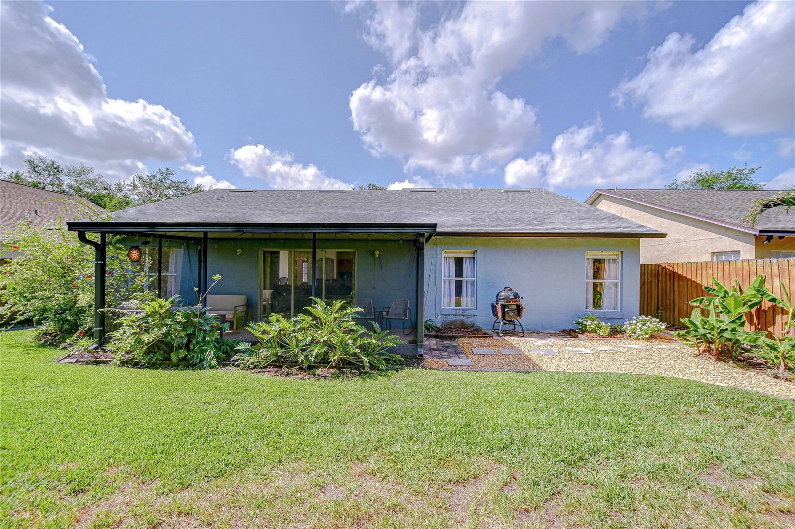 Rear view of the home showcasing the lanai enclosure.