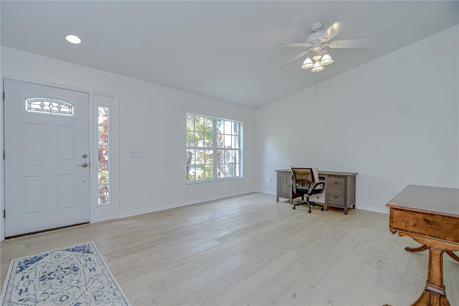 Spacious living room with abundant natural light and engineered hardwood flooring (installed 2022).