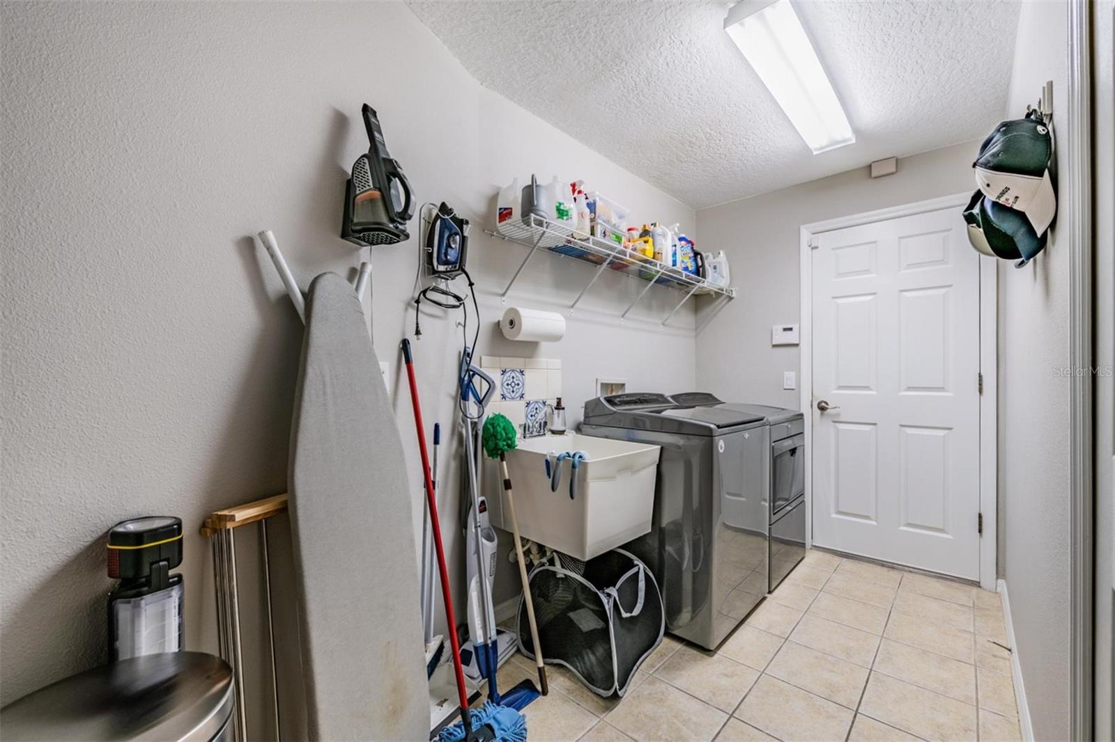 Walk-in laundry room with utility sink