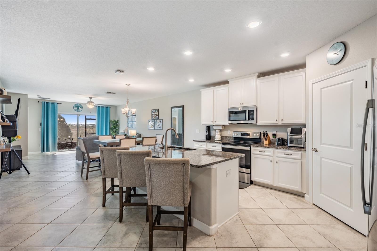 White, bright kitchen with stone counters