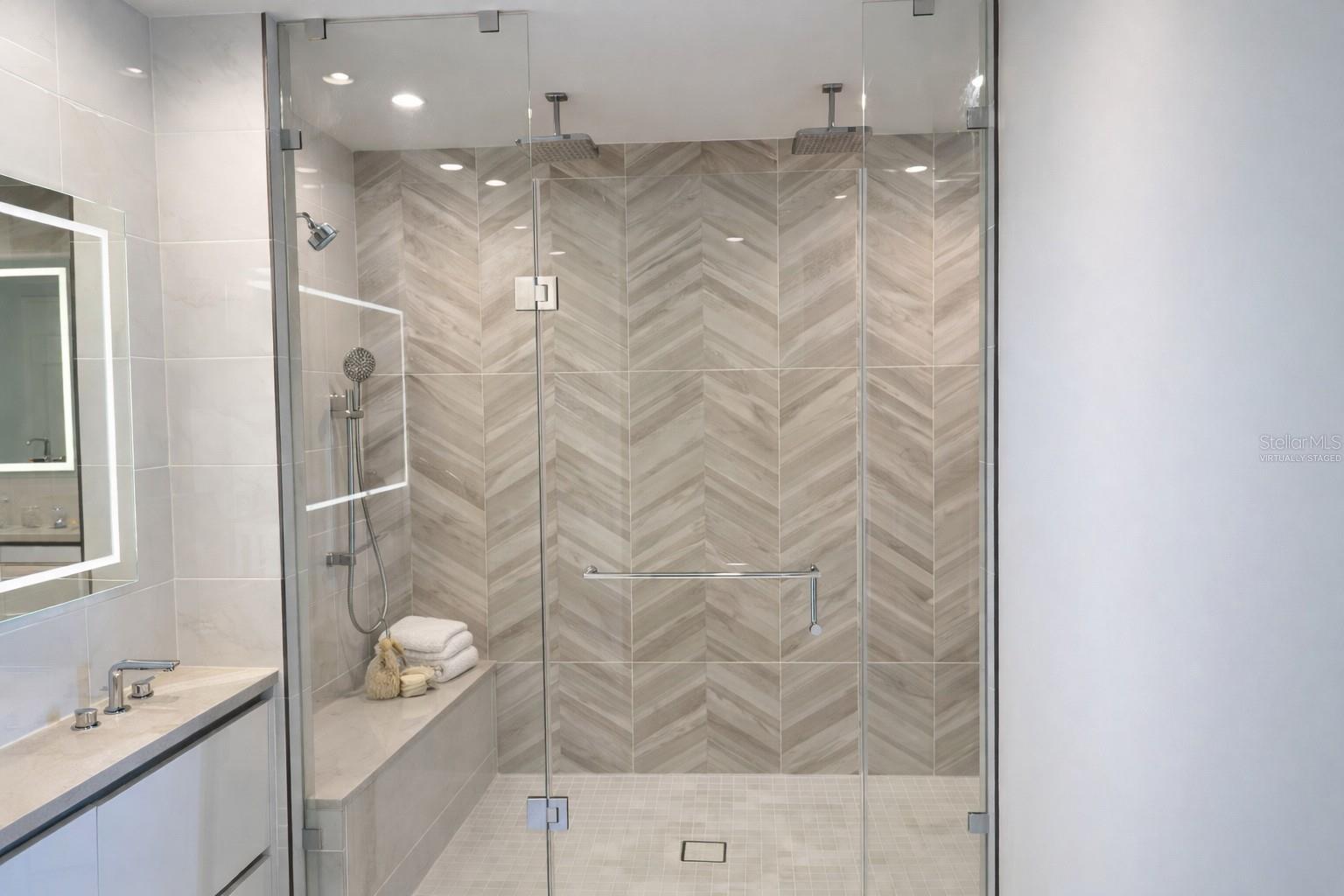 Owner Bathroom Large Frameless Glass Shower with 2 Rain Heads / 2 Additional Shower Heads and 2 Tiled Benches - Virtually Staged