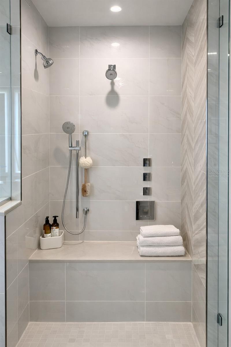 Owner Bathroom Large Frameless Glass Shower with 2 Rain Heads / 2 Additional Shower Heads and 2 Tiled Benches - Virtually Staged