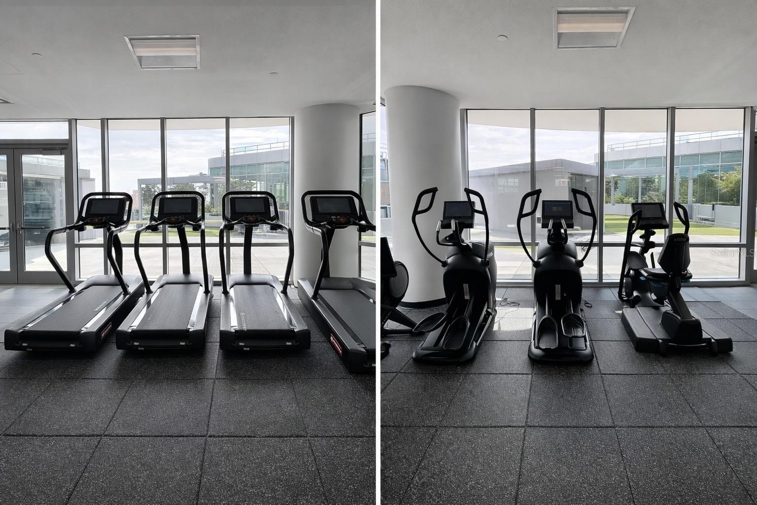 Amenities - Large Fitness Center with Equipment Overlooking water view and city